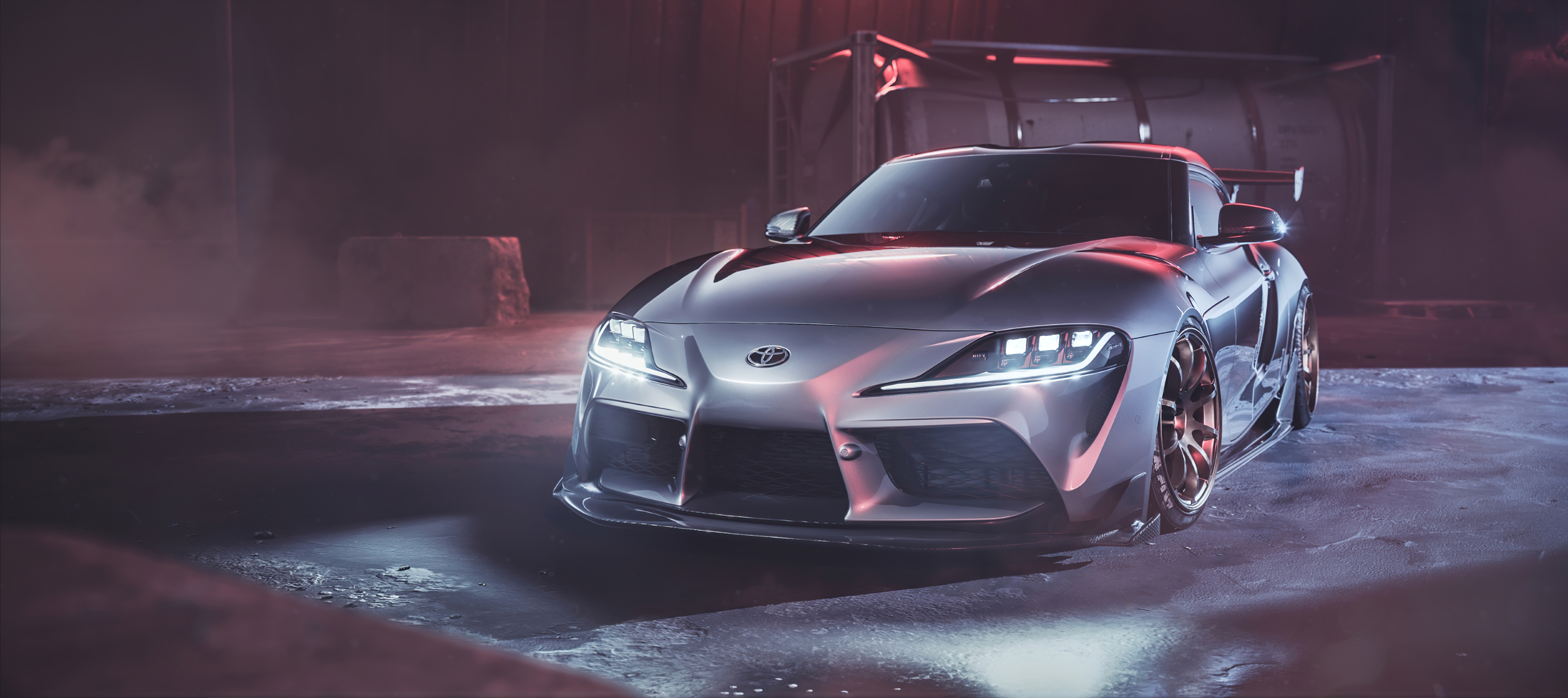 Silver Toyota Supra Sports Car in Smoky Industrial Setting HD Wallpaper