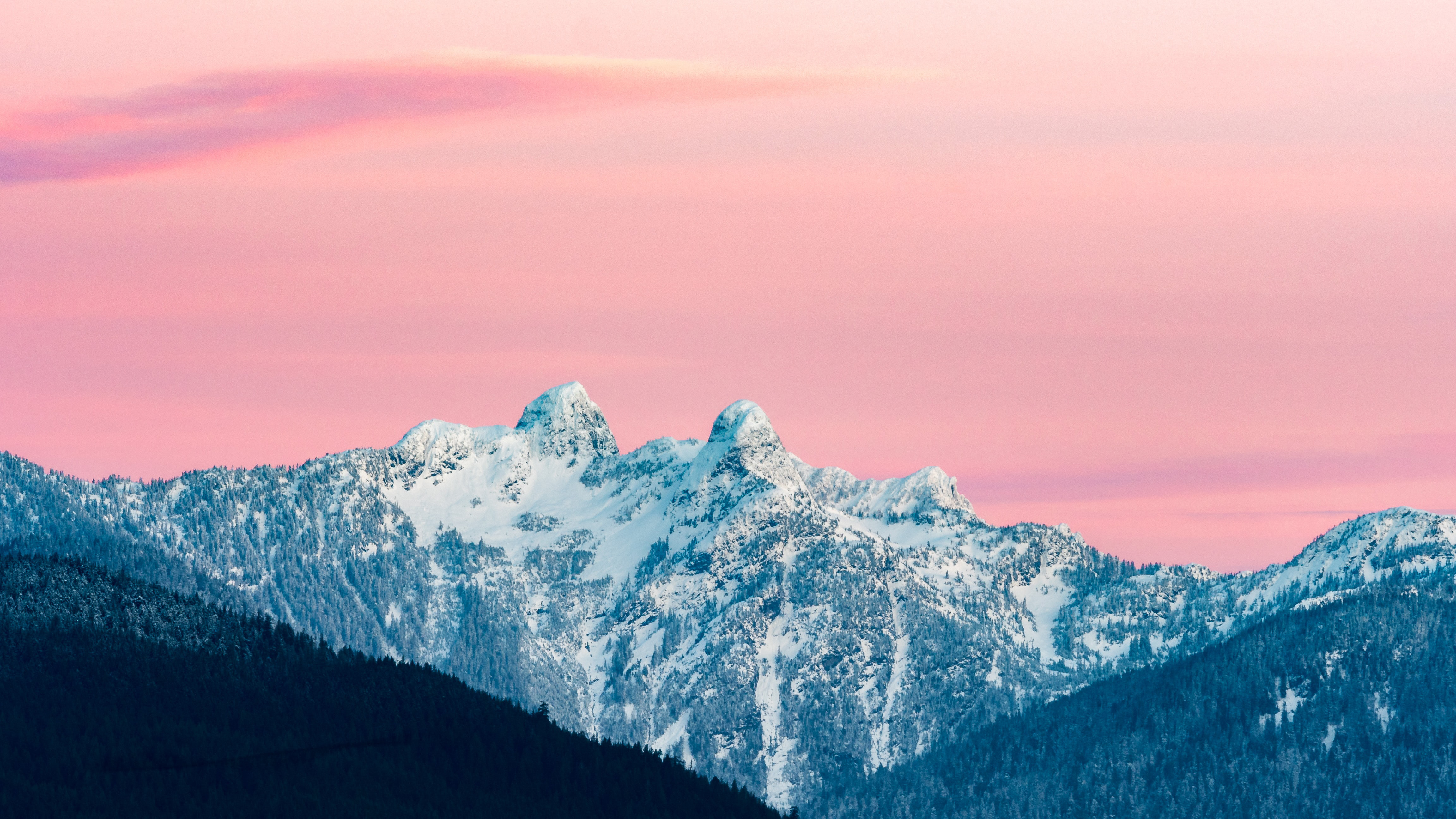 Snow-covered mountains under a pink sky HD Wallpaper