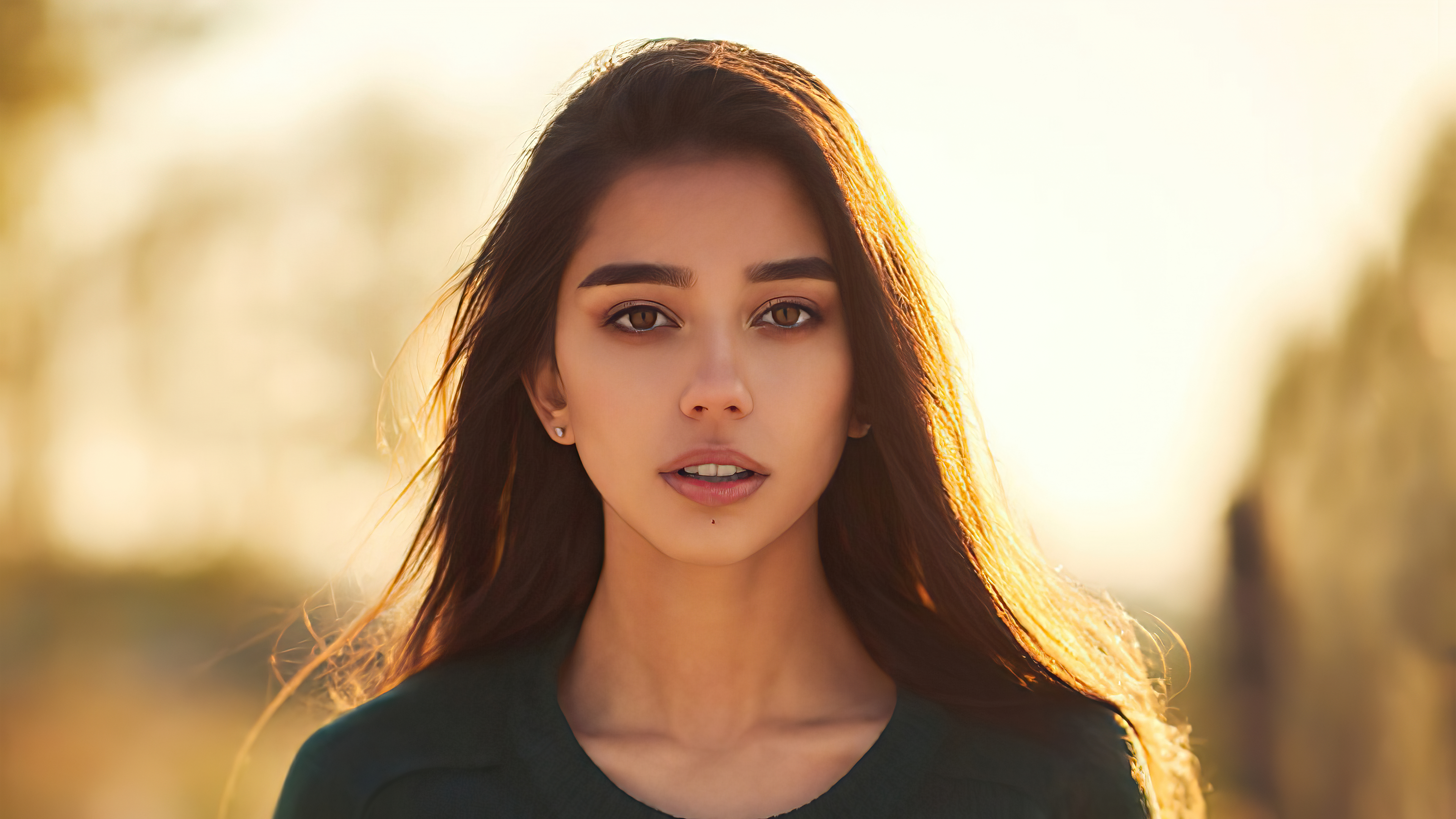 Young woman with long dark hair in golden light HD Wallpaper