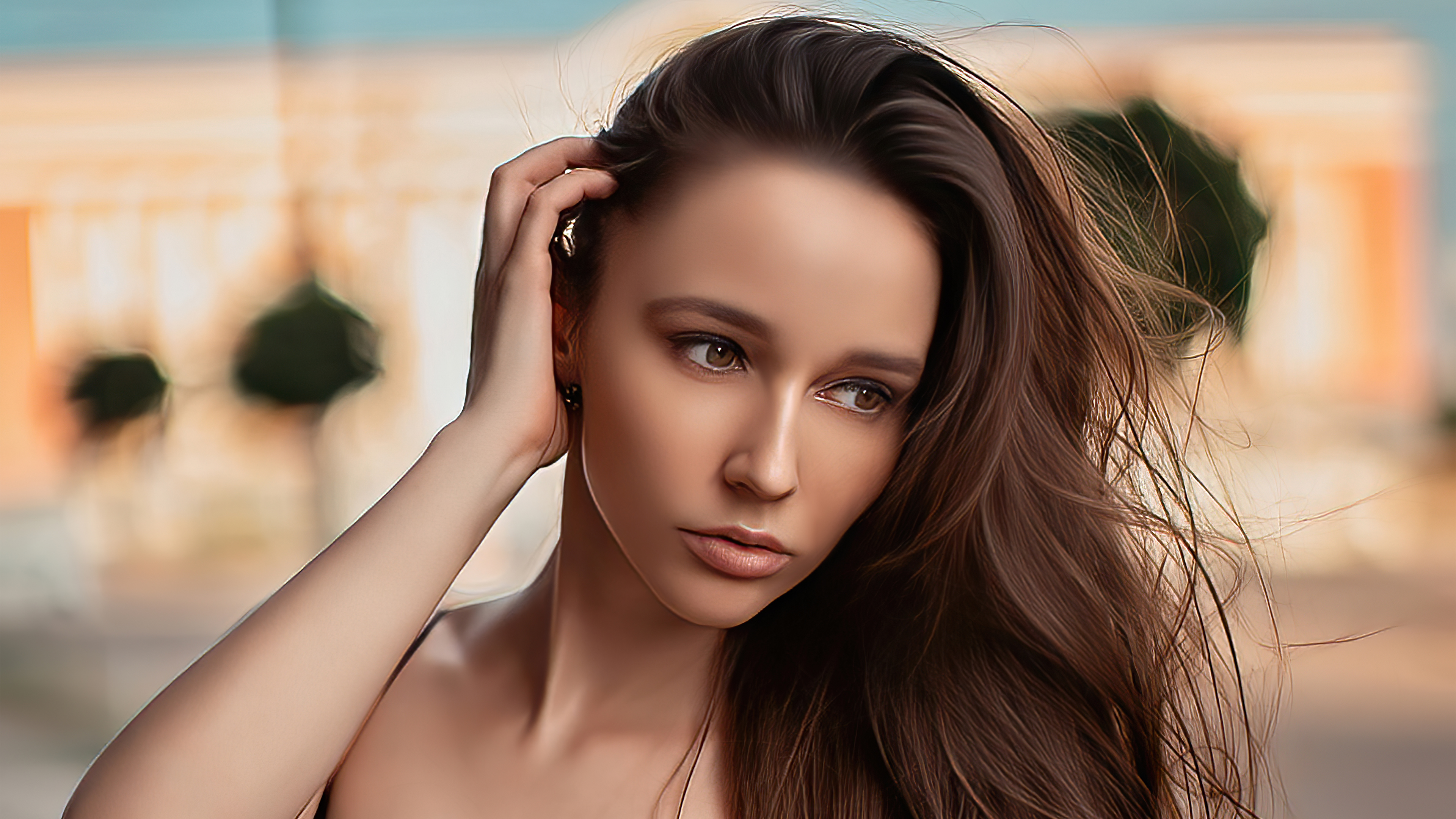 Woman with hand in hair, outdoor portrait HD Wallpaper
