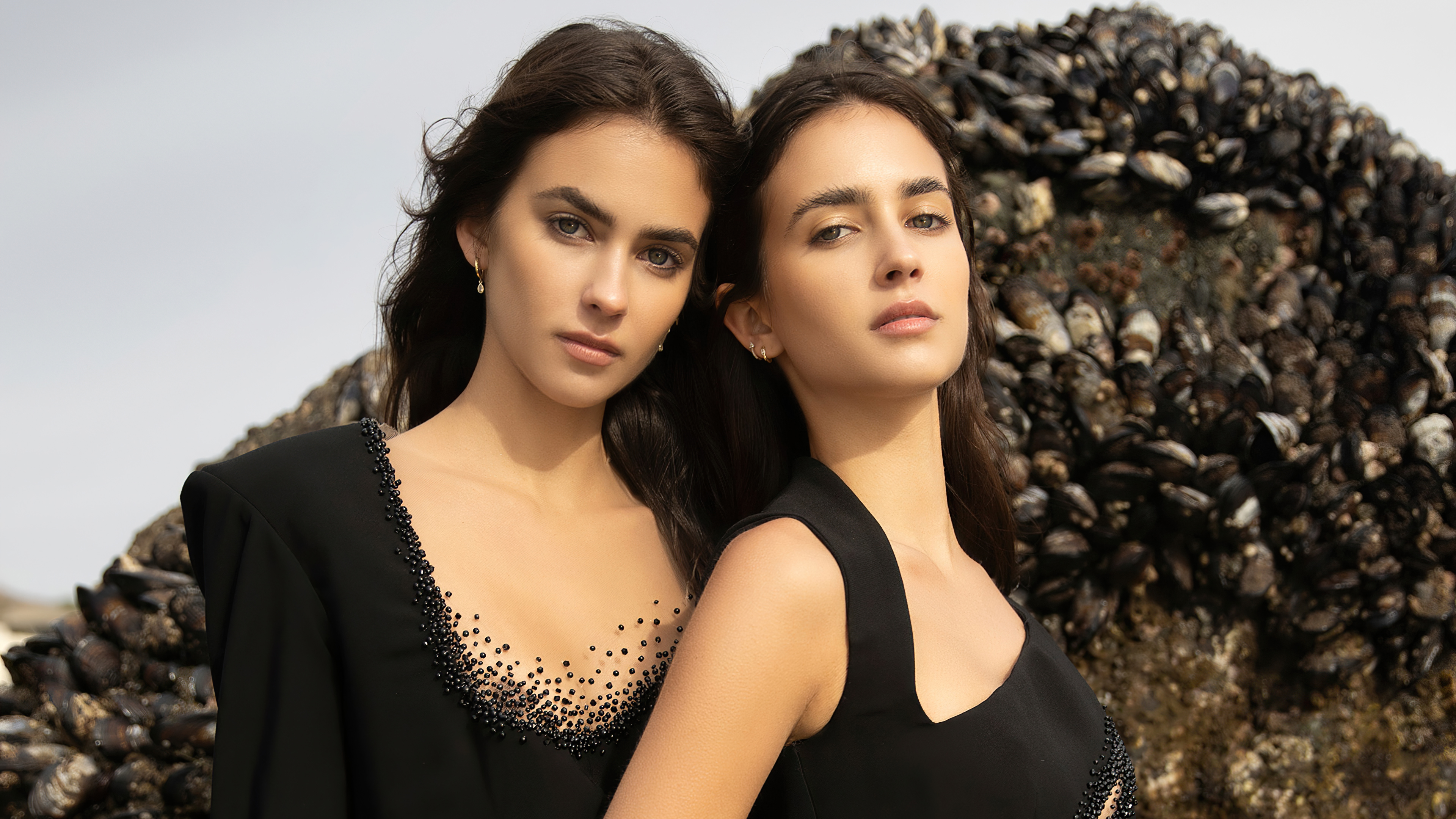 Two models in black dresses by the sea HD Wallpaper