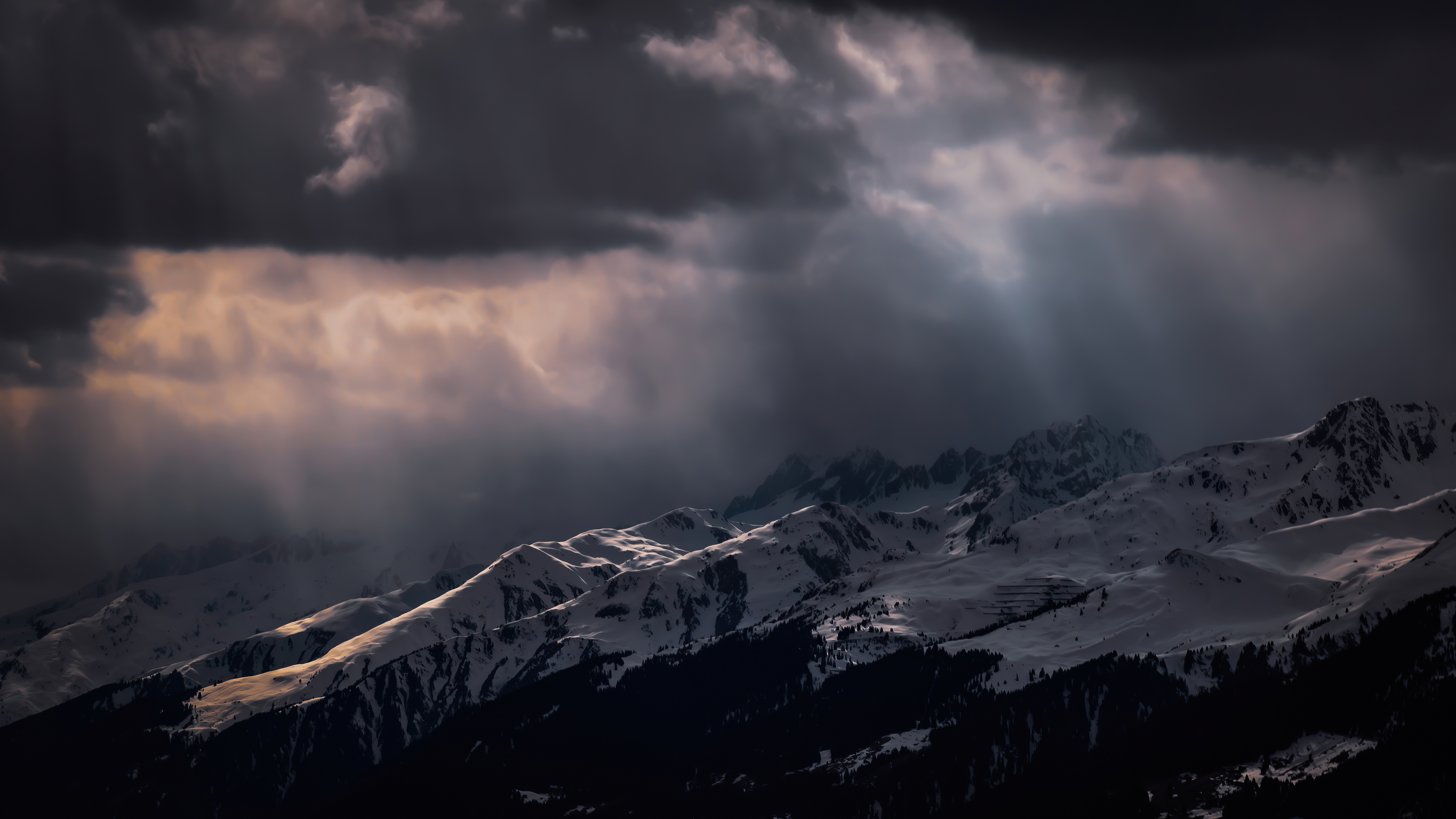 Snowy mountains under dramatic storm clouds HD Wallpaper
