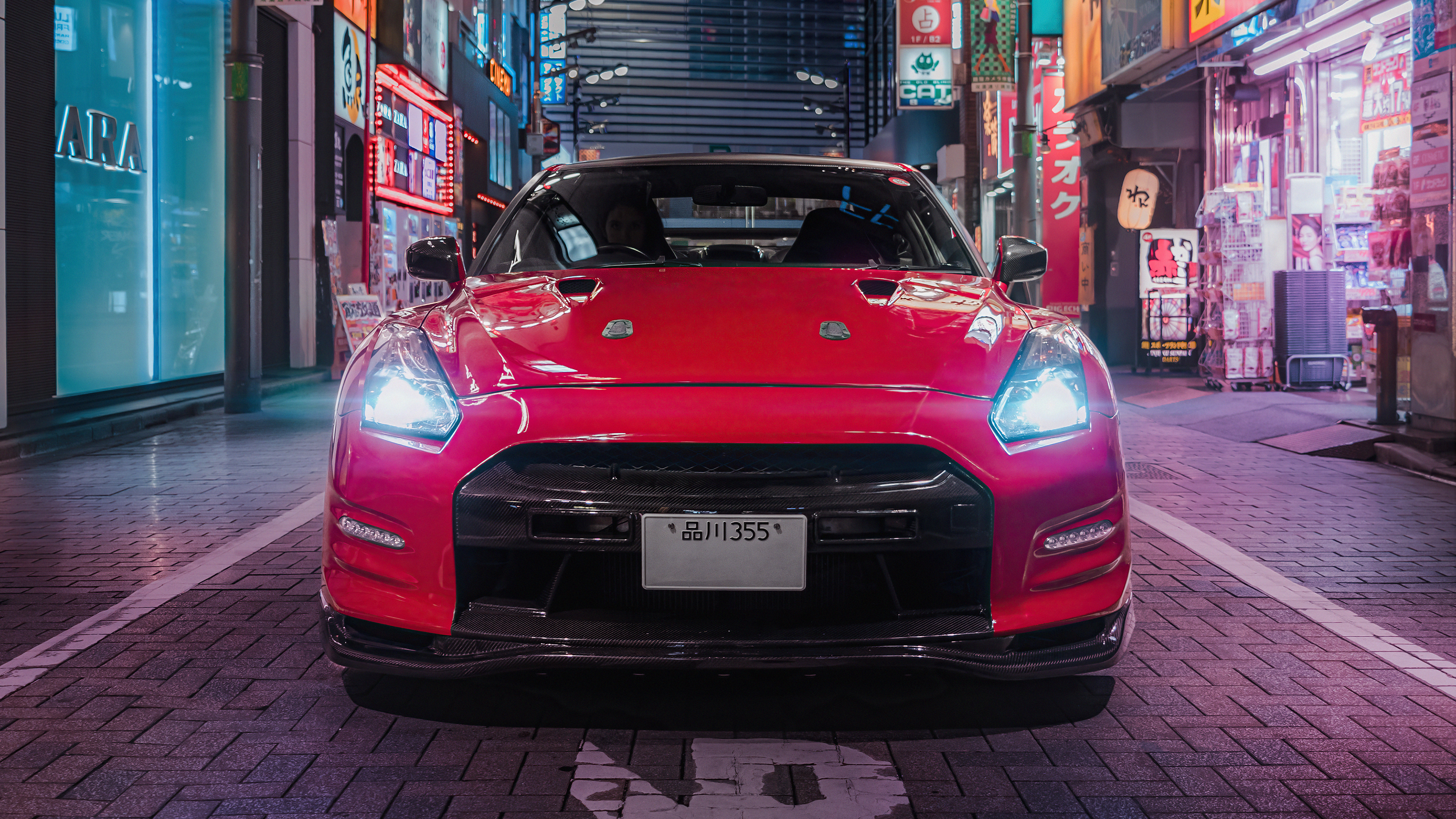 Red Nissan GT-R parked on a street in Tokyo HD Wallpaper