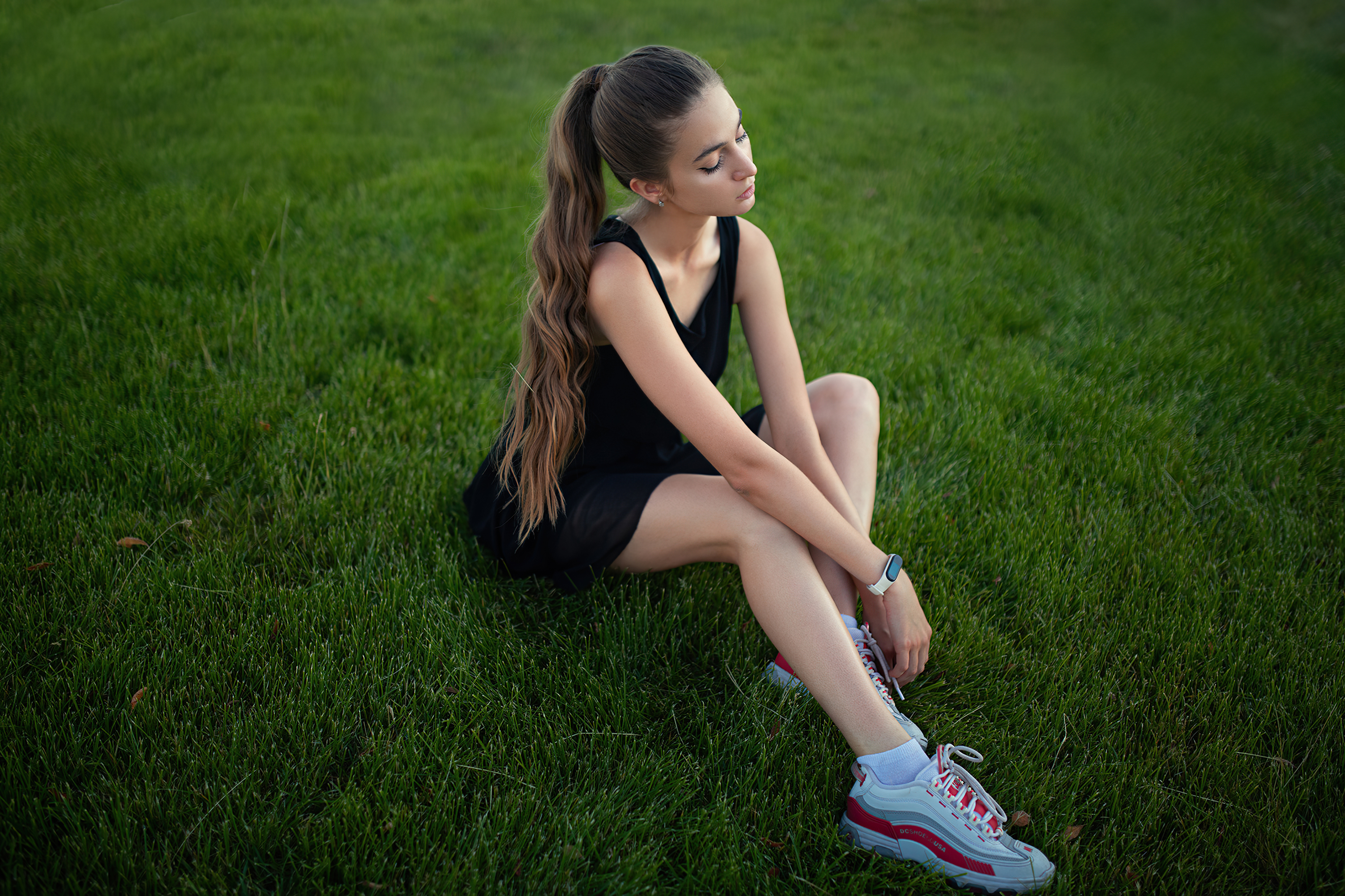 Young Woman Sitting on Grass in 4K HD Wallpaper