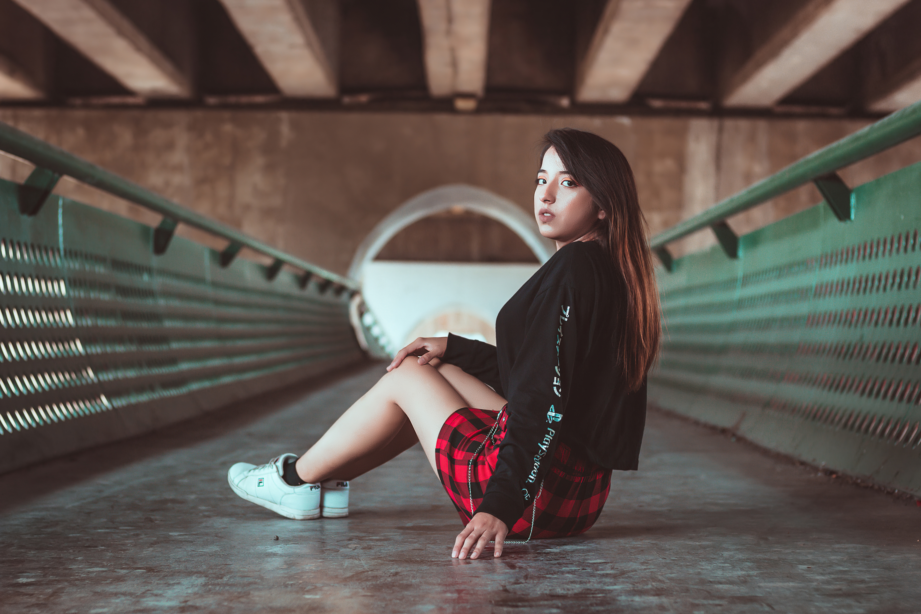Girl in plaid skirt sitting under bridge HD Wallpaper