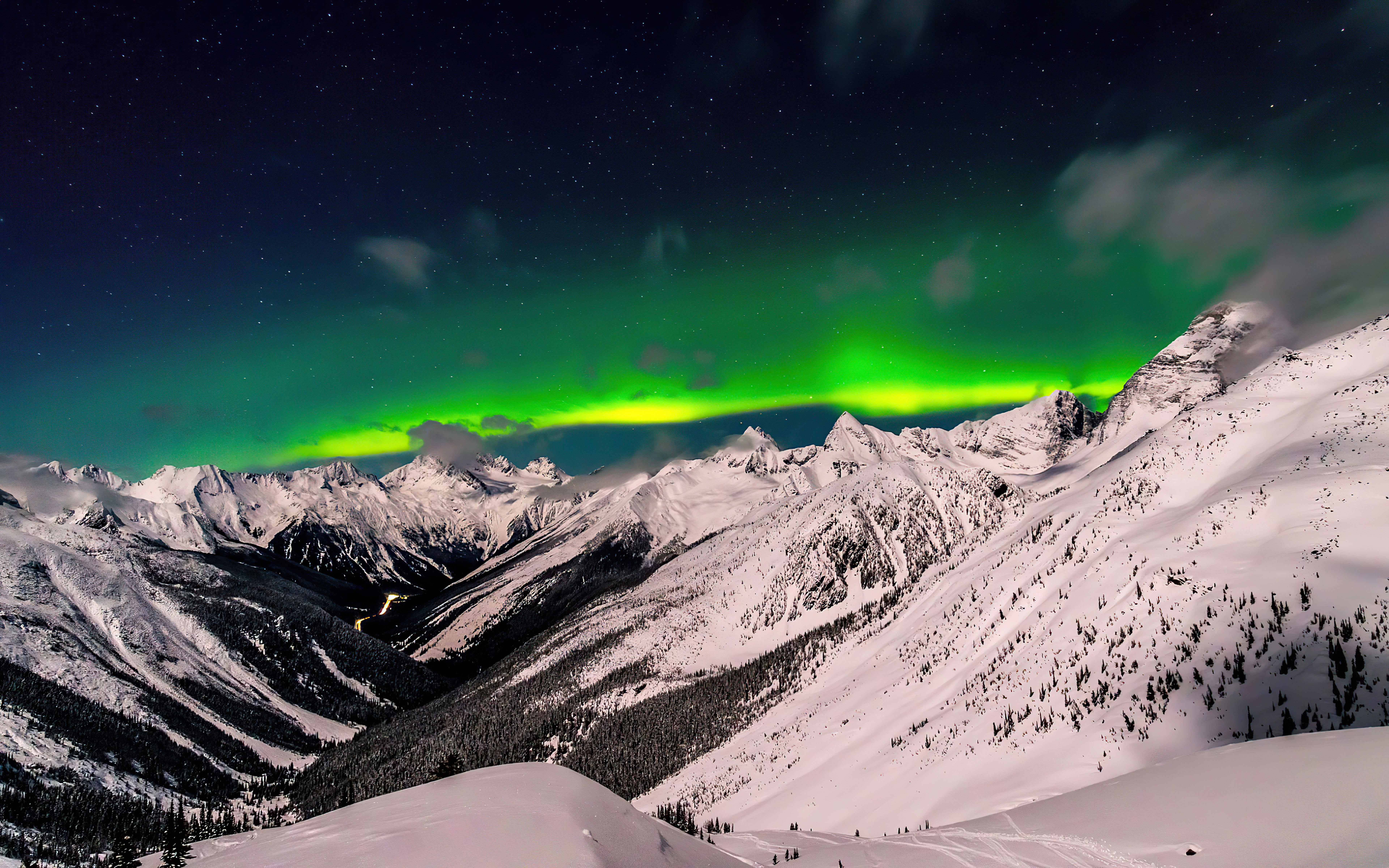 Aurora Borealis over snow-covered mountains HD Wallpaper