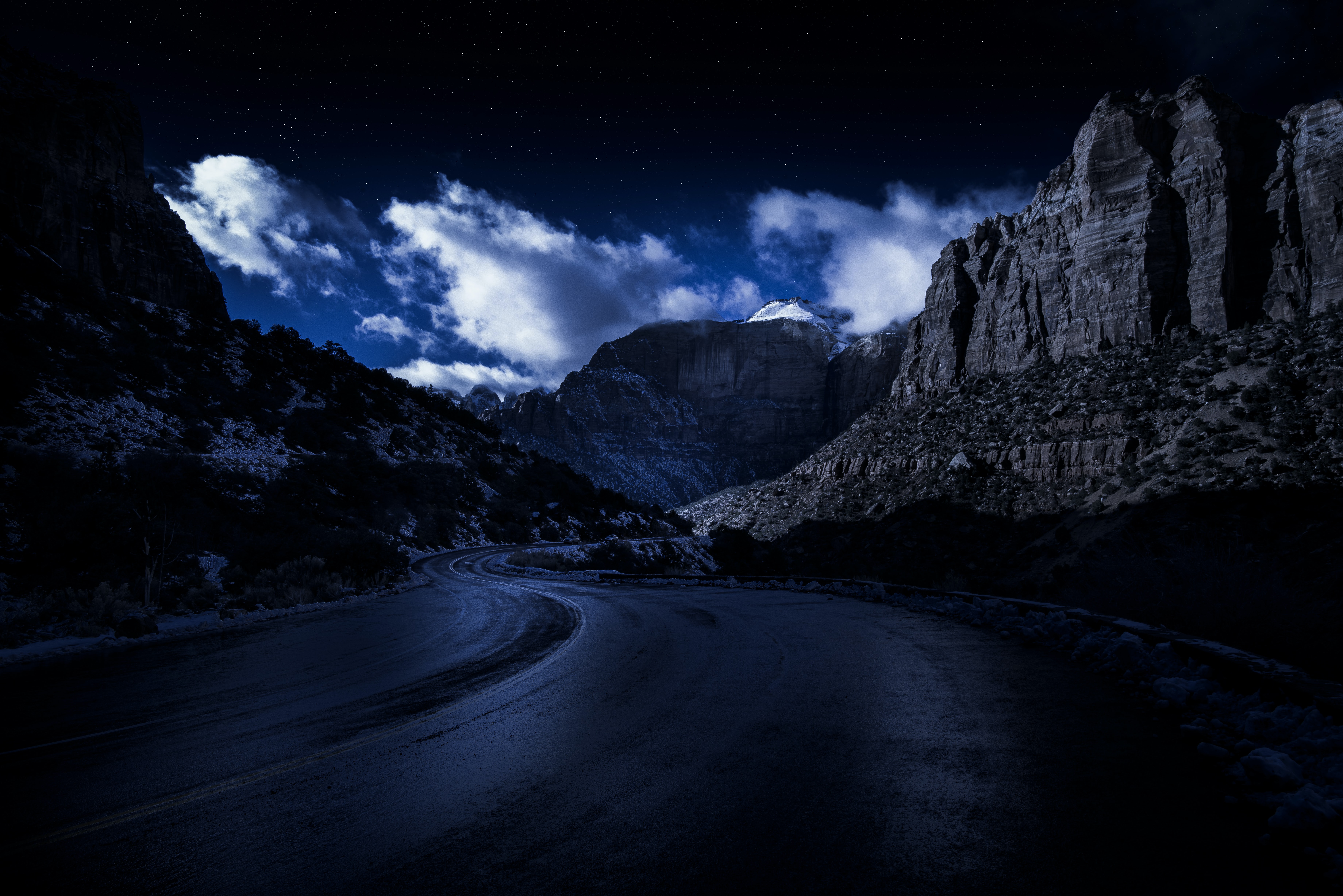 Mountain road at night with clouds and stars HD Wallpaper