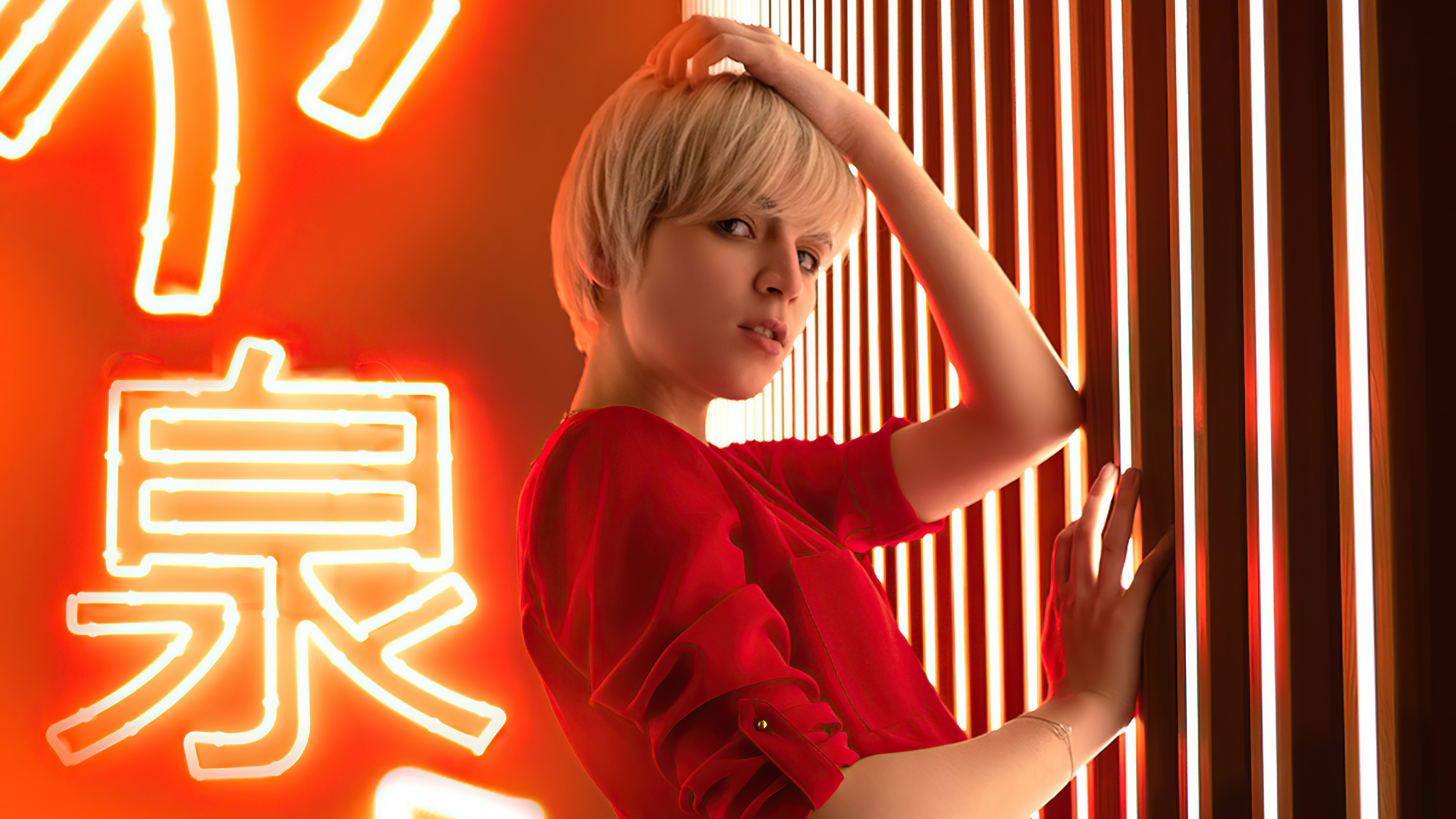 Model with blonde hair in red shirt near neon sign HD Wallpaper
