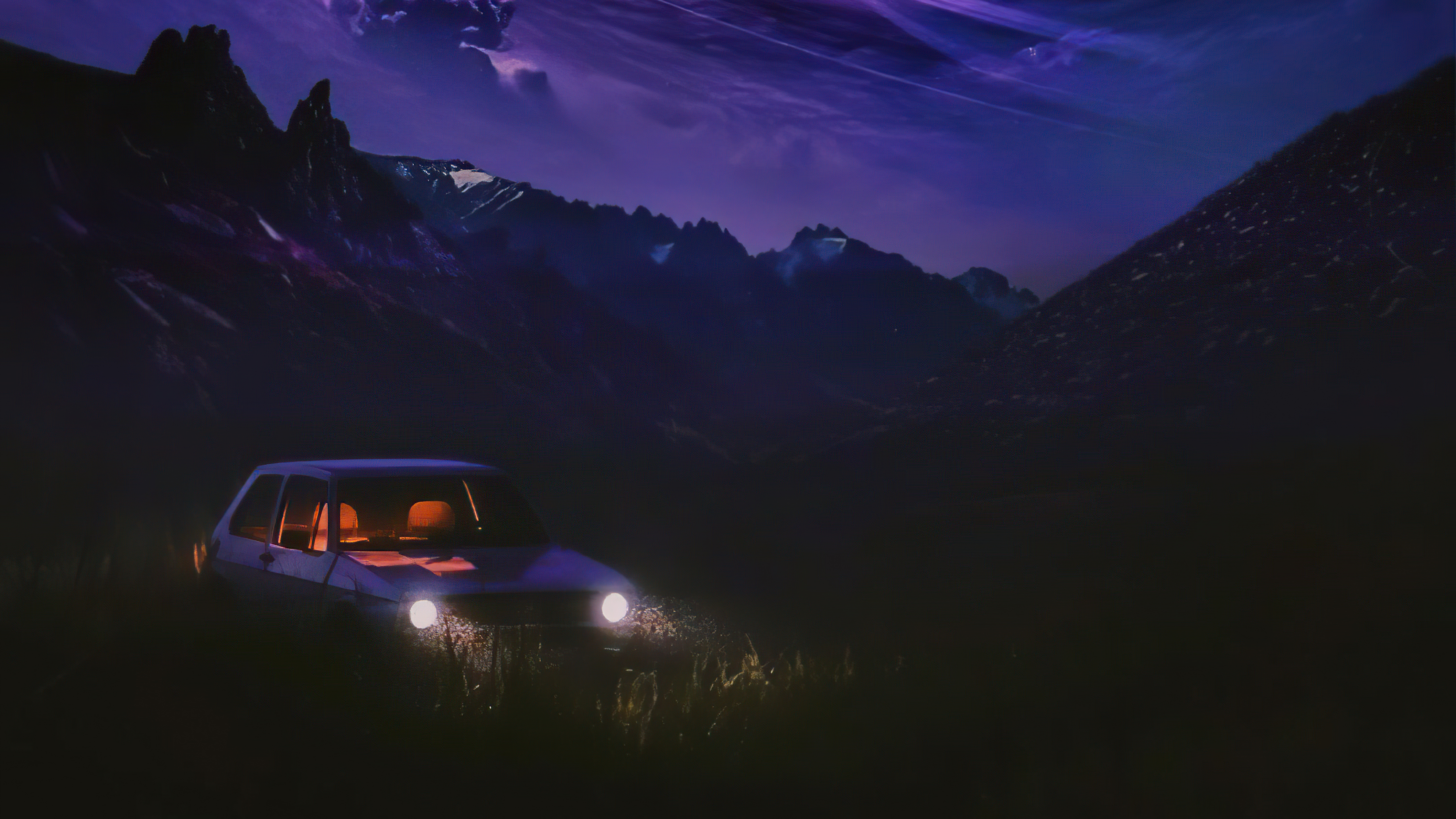 Car parked in a dark mountain landscape at night HD Wallpaper