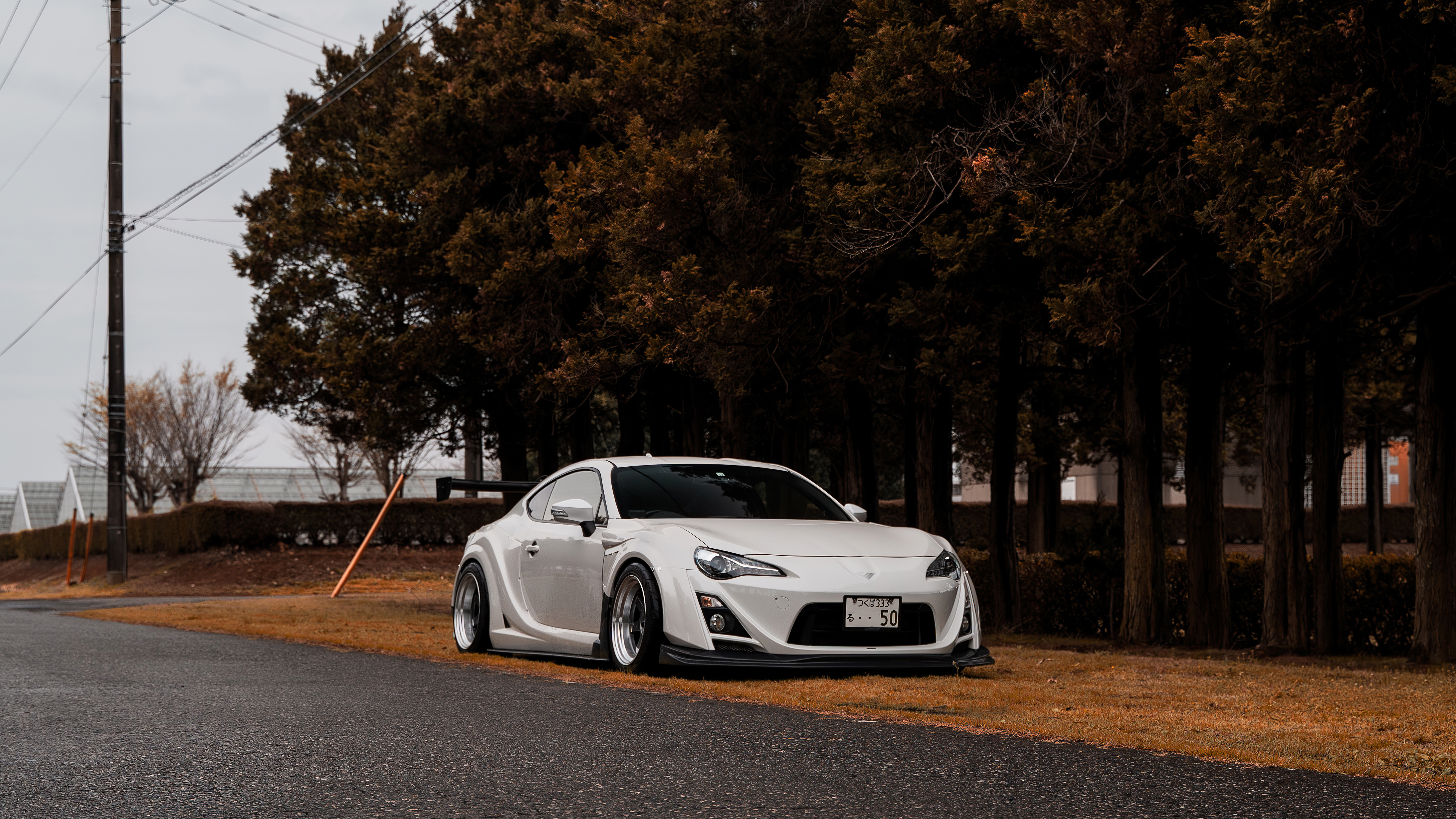 White Toyota GT86 with spoiler on road HD Wallpaper