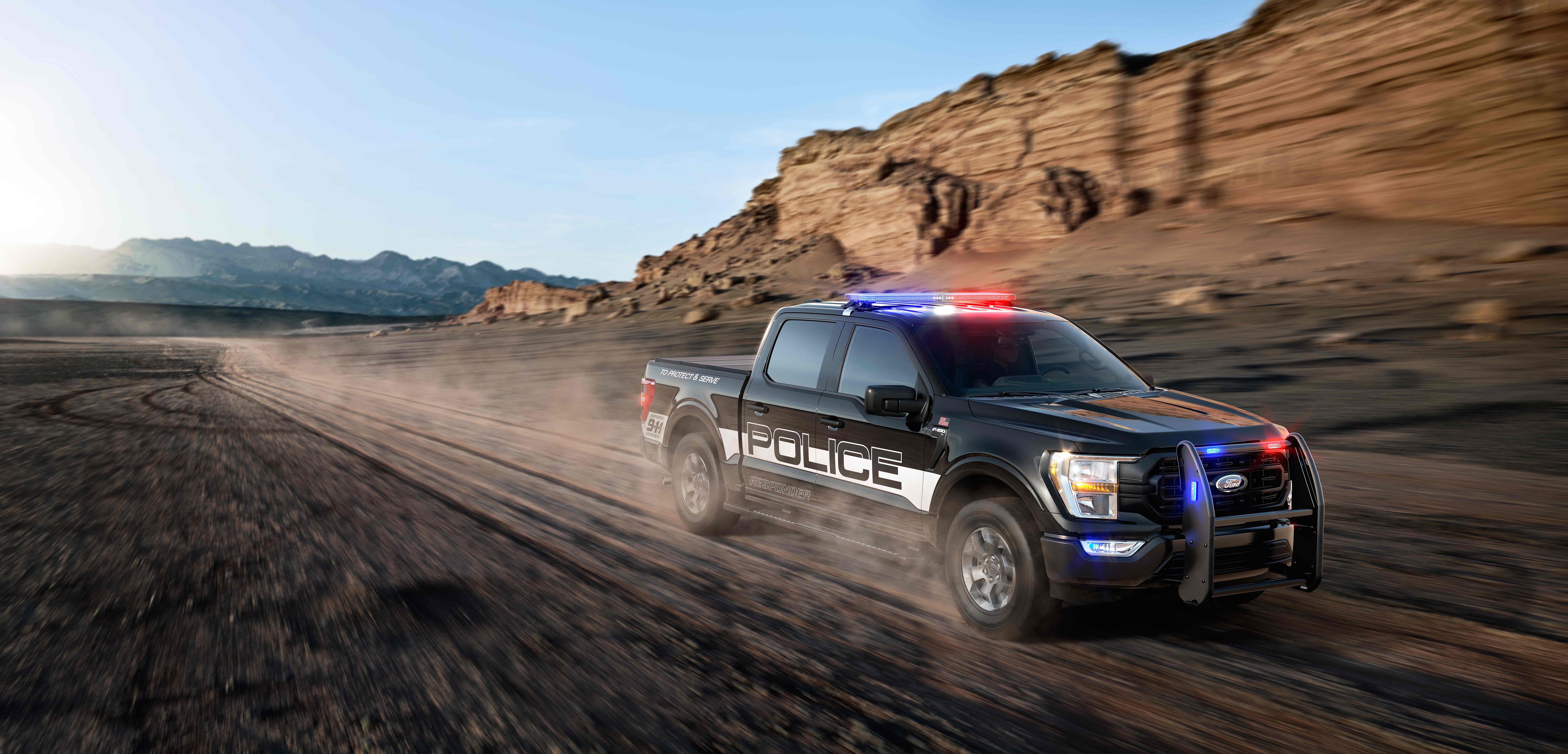 Ford F-150 Police Interceptor driving on dirt road HD Wallpaper