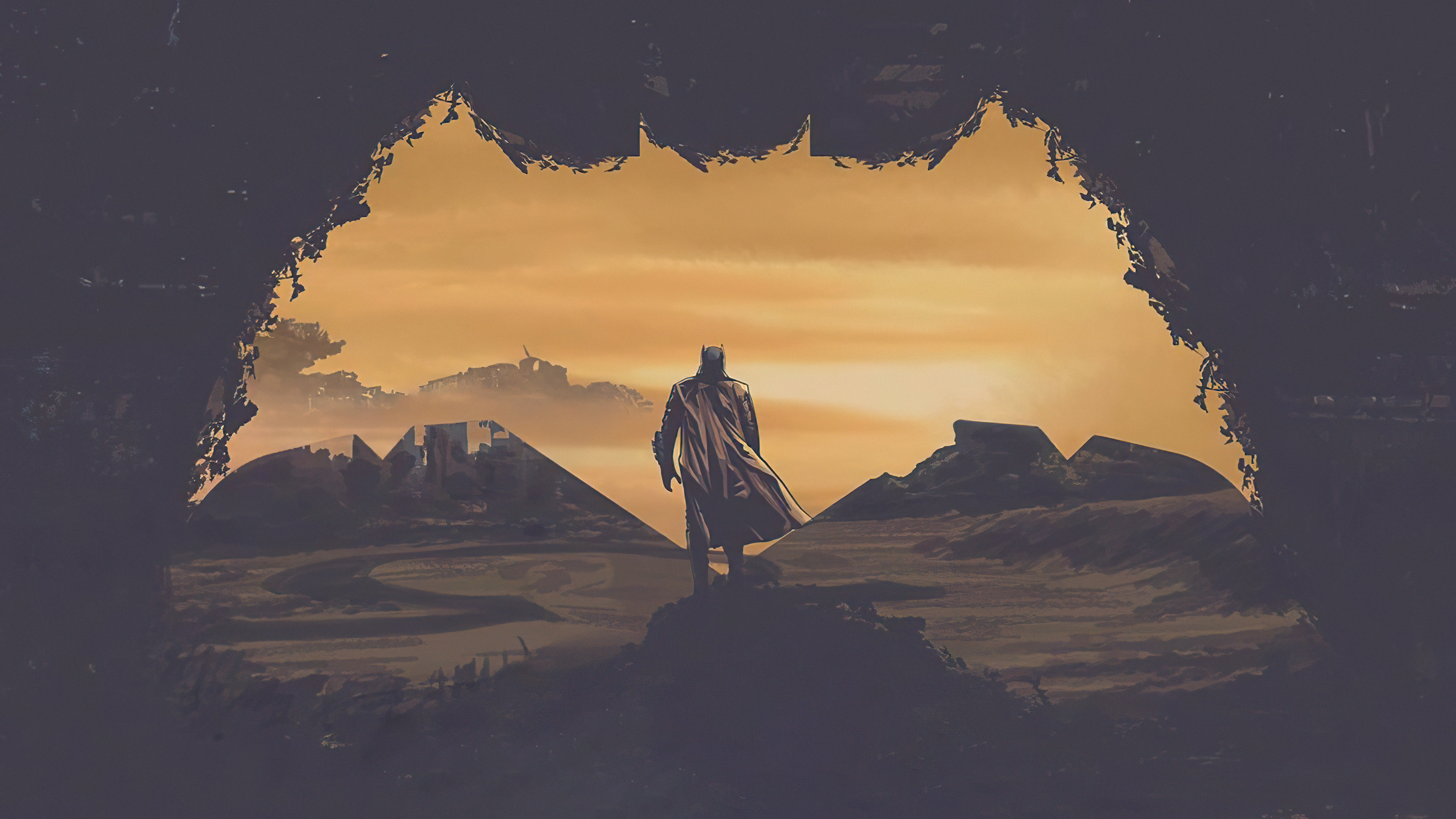 Batman in a desolate landscape framed by a bat symbol HD Wallpaper