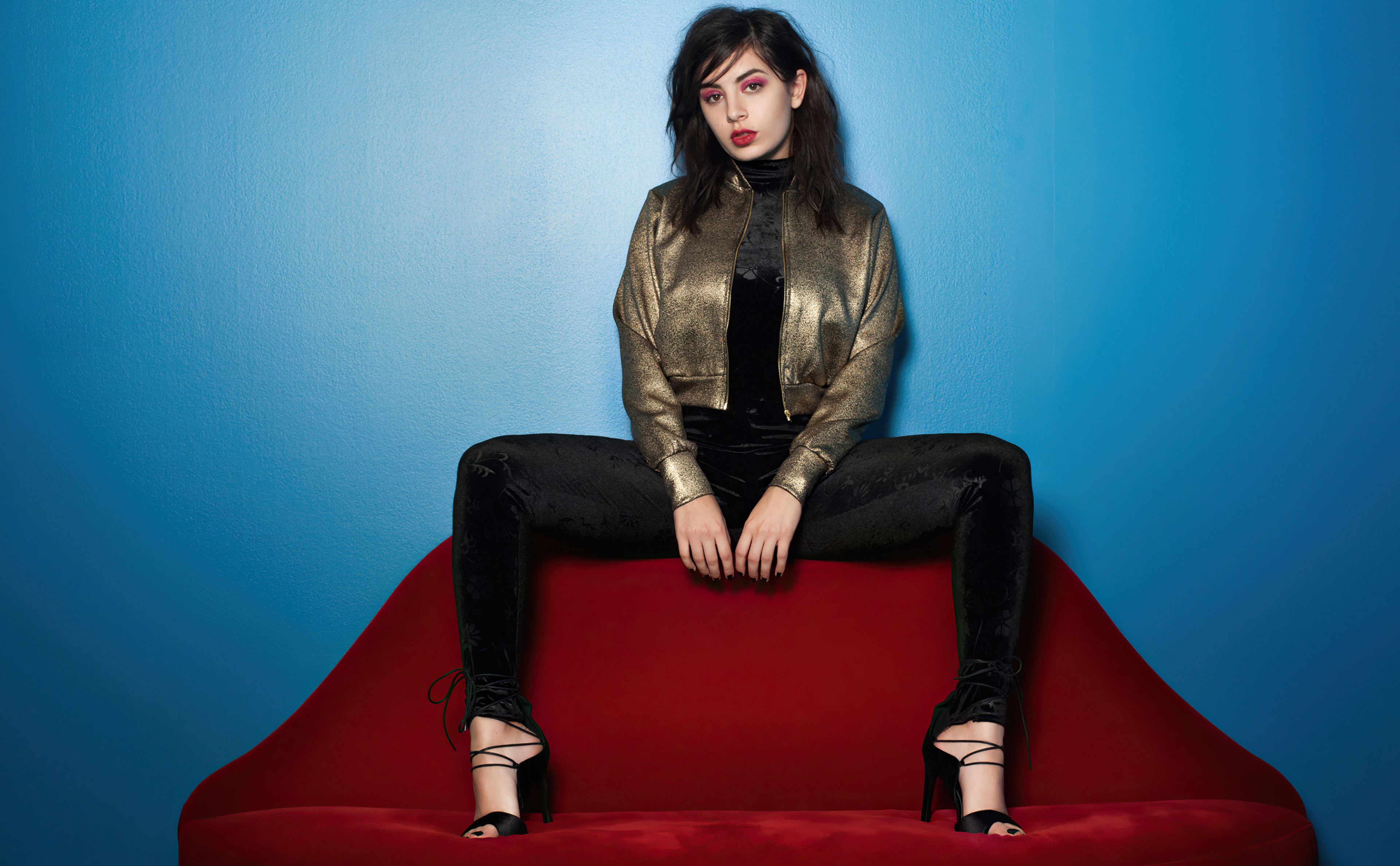 Charli XCX on a red couch HD Wallpaper