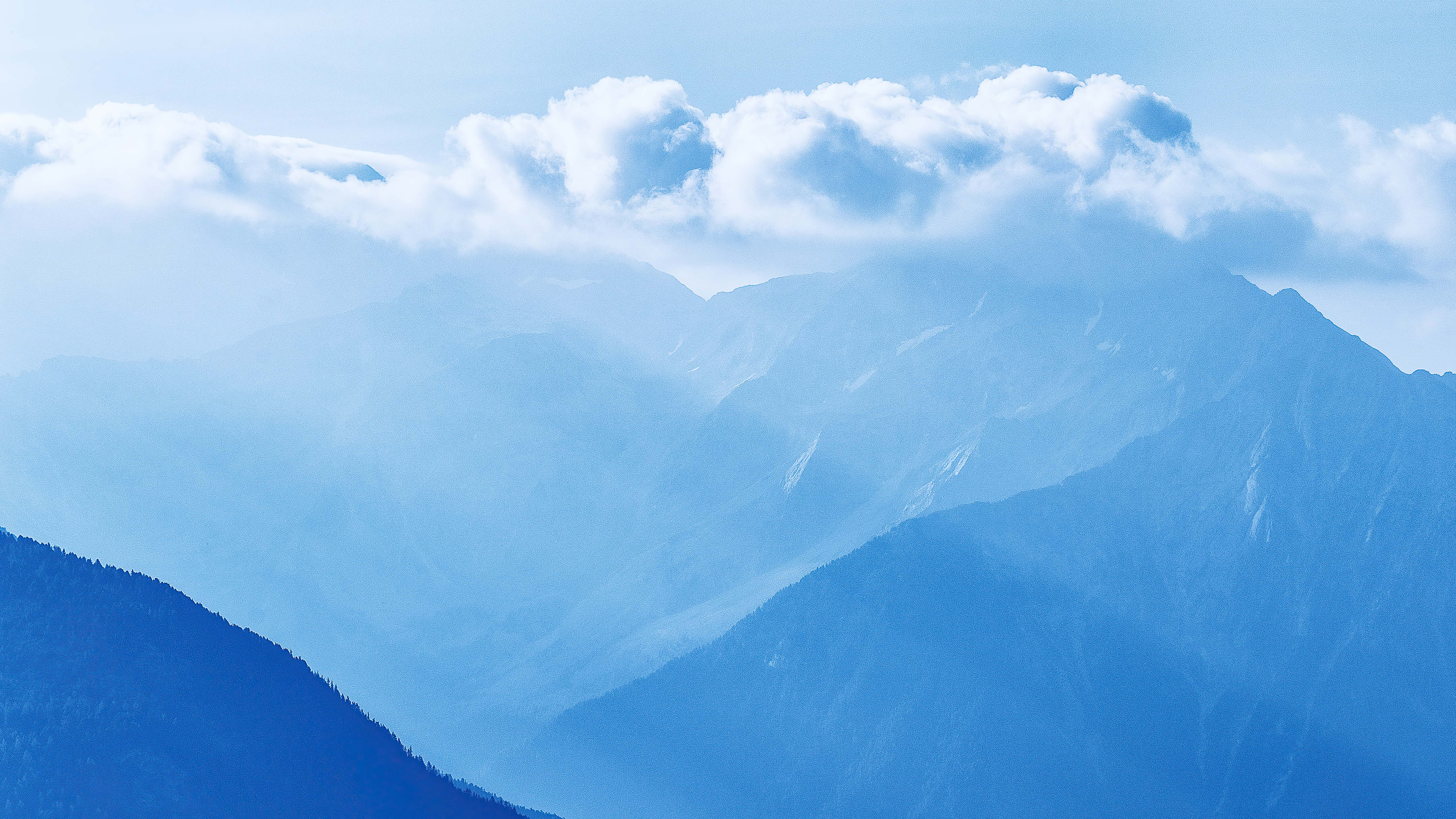 Misty mountains with clouds in blue sky HD Wallpaper