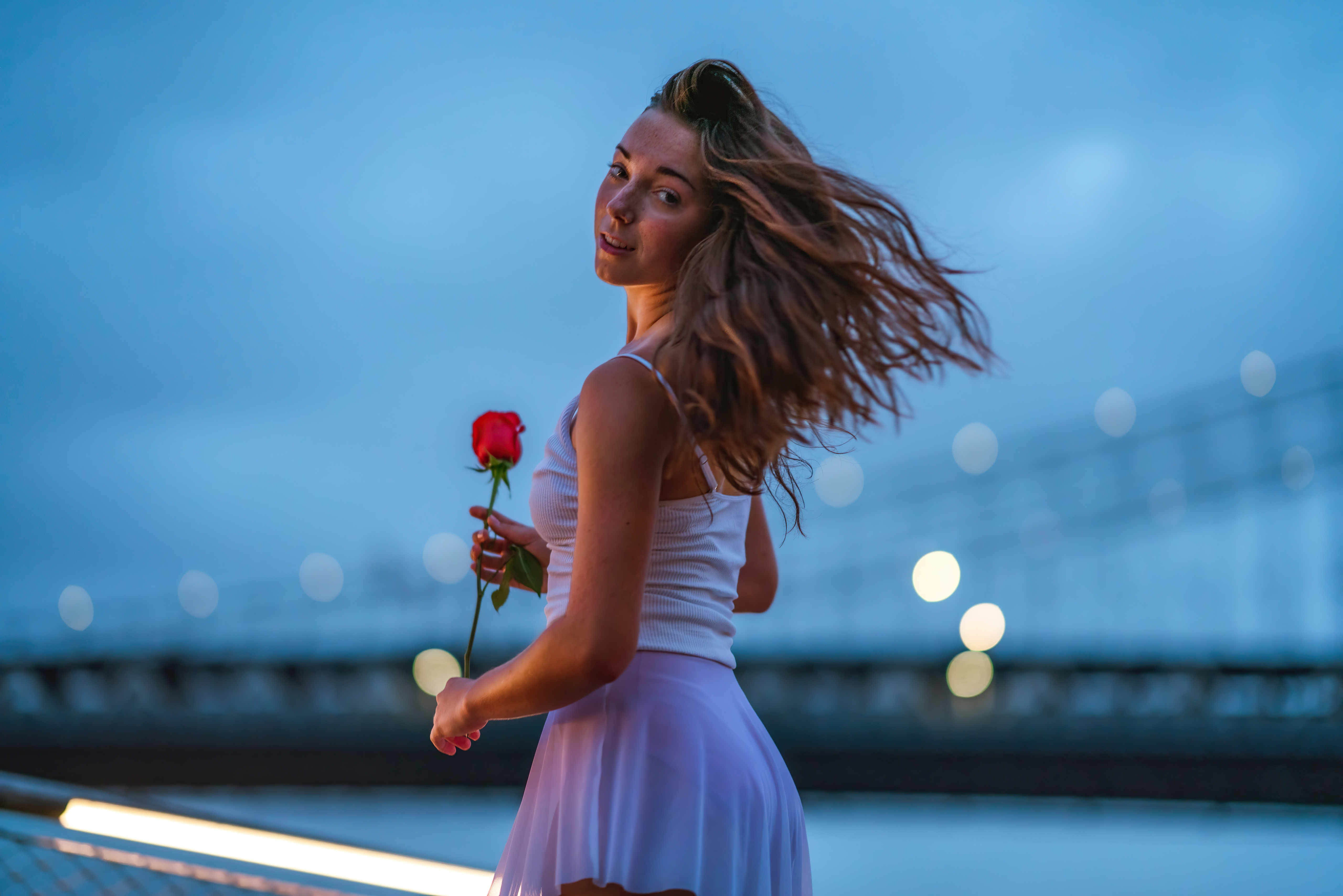 Model with a red rose at dusk HD Wallpaper