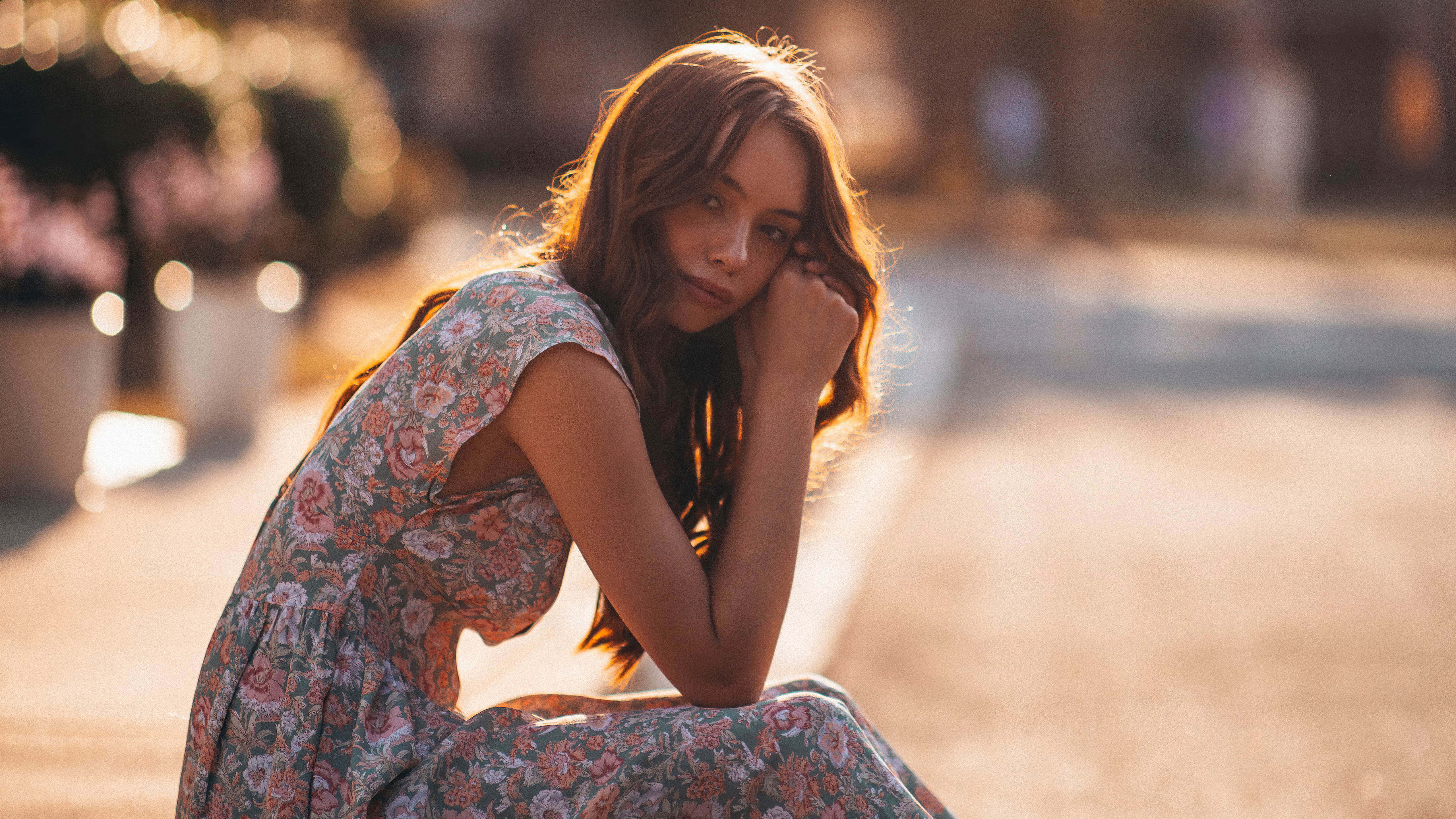 Girl in floral dress sitting outdoors HD Wallpaper