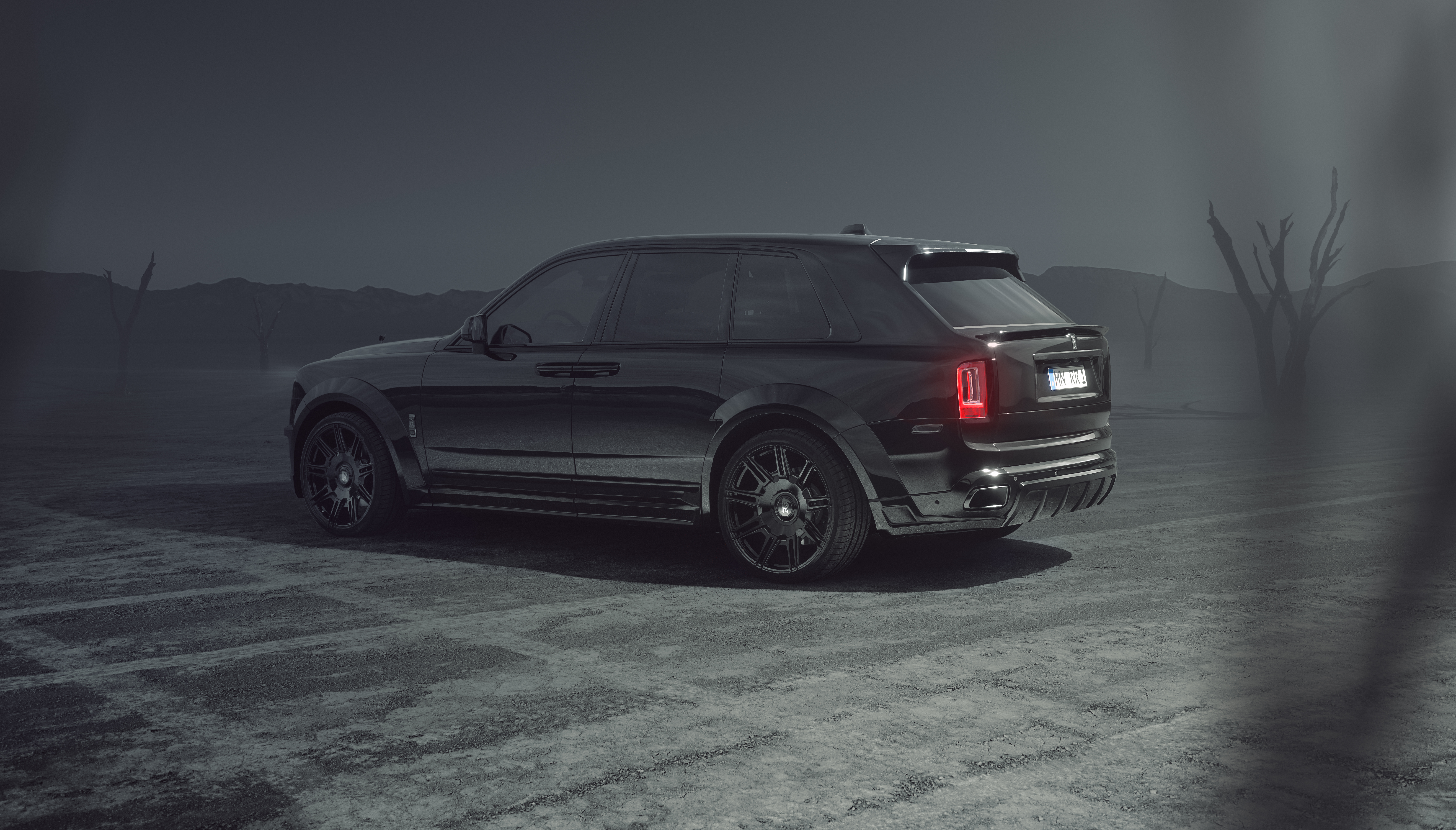 Black Rolls Royce Cullinan in a desolate landscape HD Wallpaper