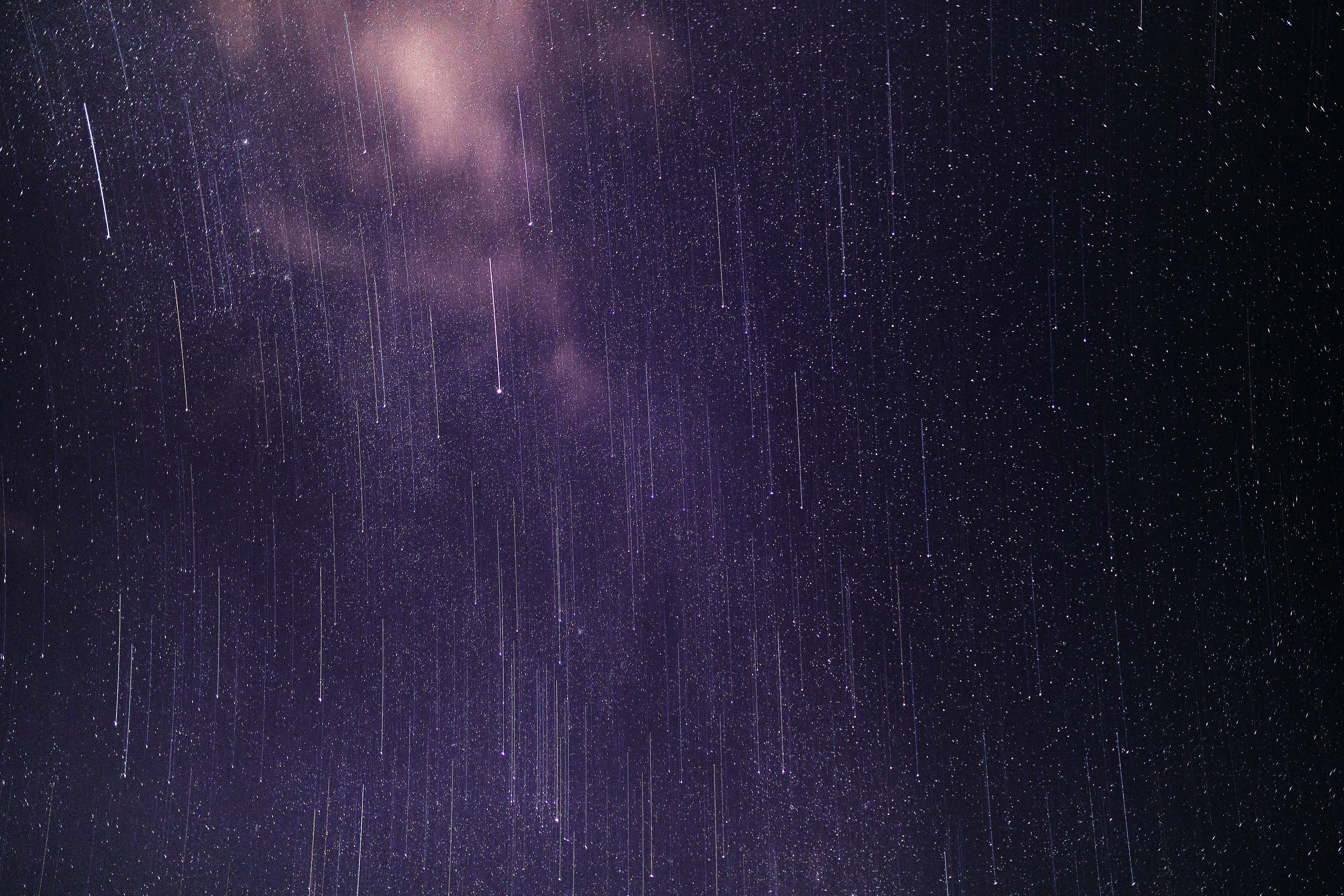 Meteors streaking across a starry night sky HD Wallpaper