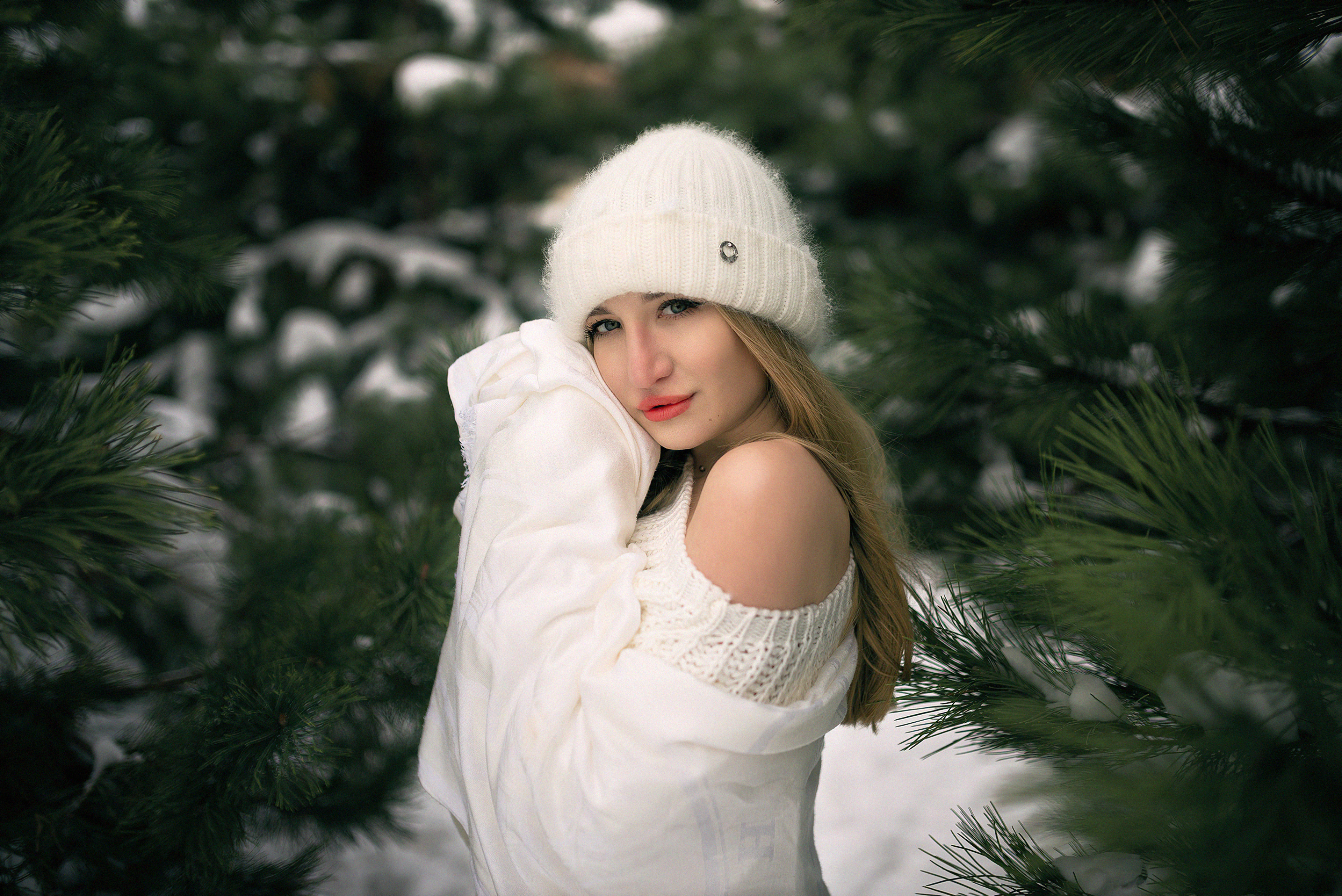 Girl in white hat and jacket in snow among pine trees HD Wallpaper