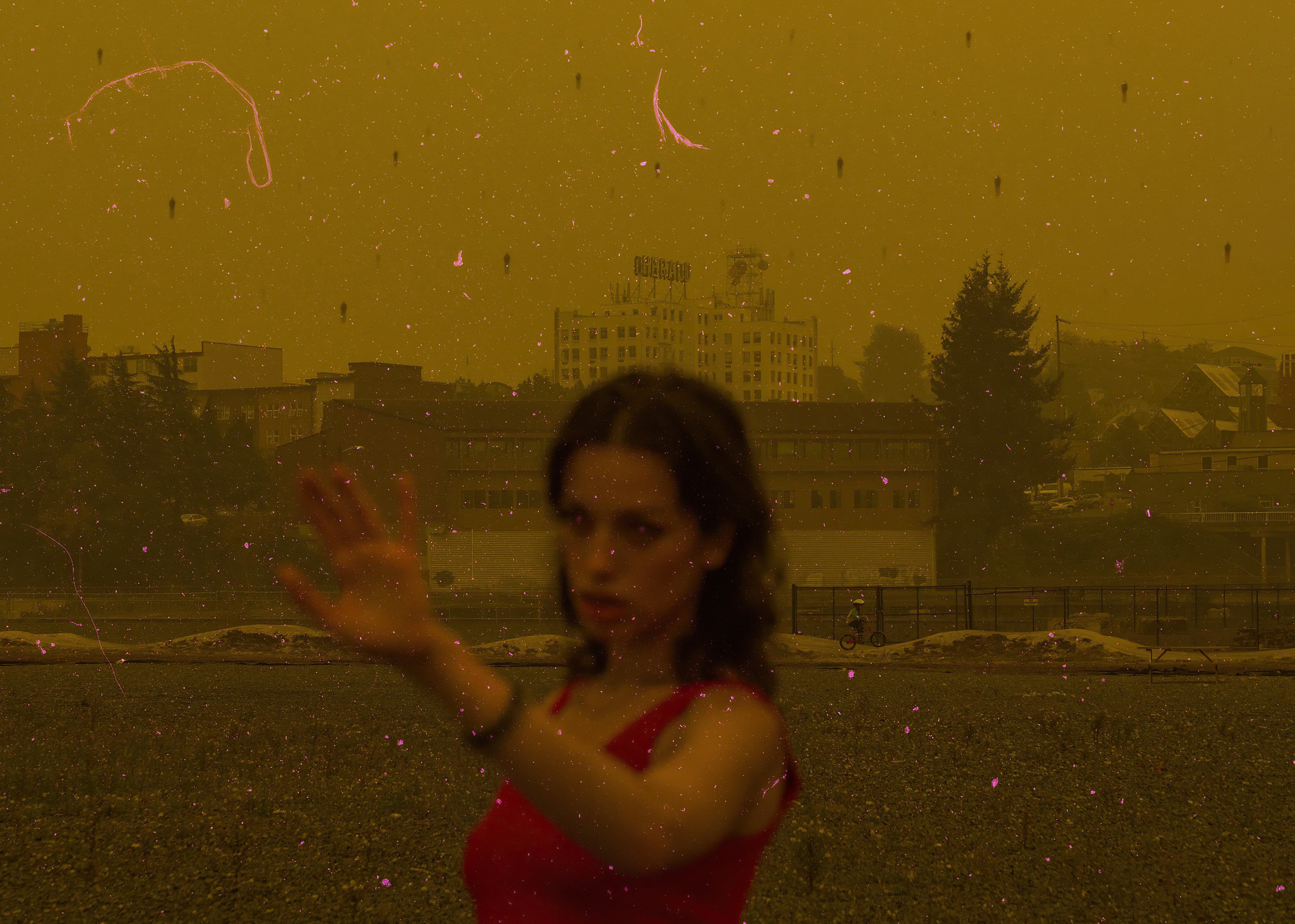 Woman in red dress with outstretched hand, city skyline background HD Wallpaper