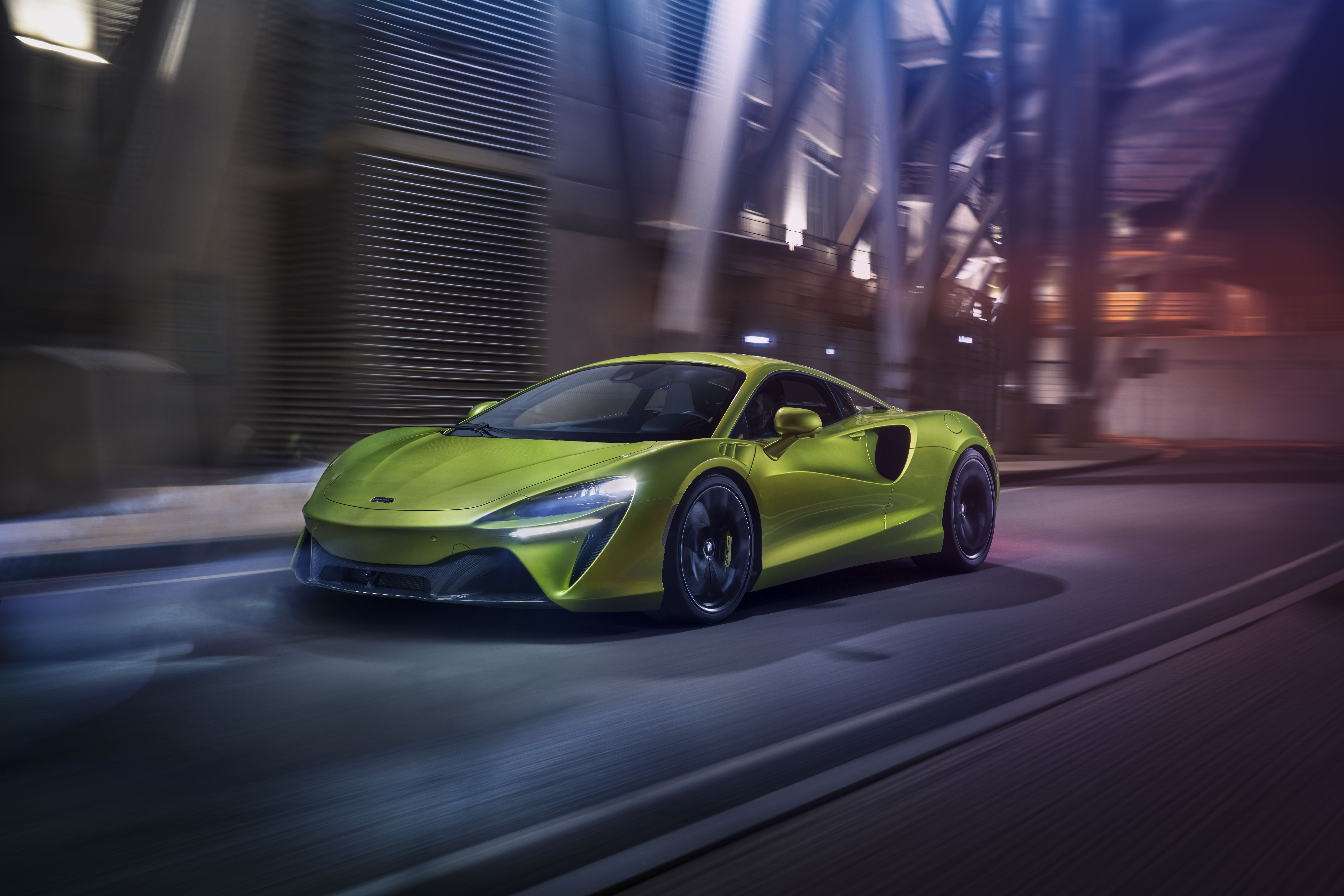 Green McLaren Artura driving through a city at night HD Wallpaper
