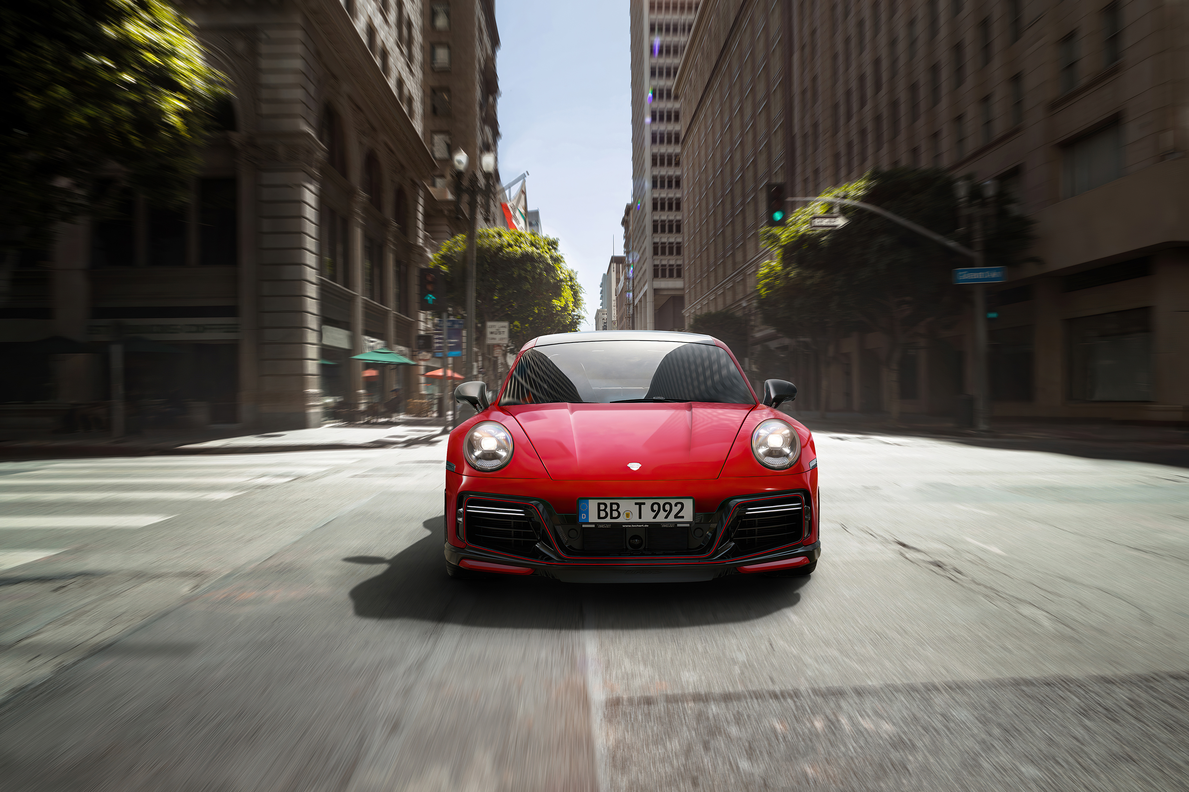 Red Porsche 911 driving in city HD Wallpaper