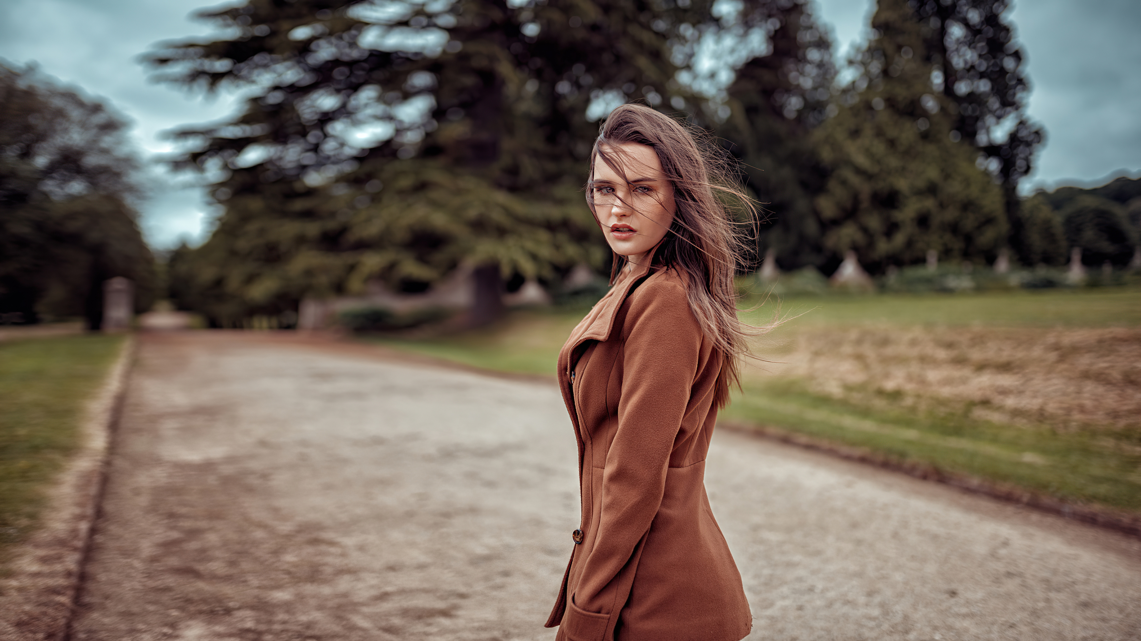 Woman in brown coat in park HD Wallpaper