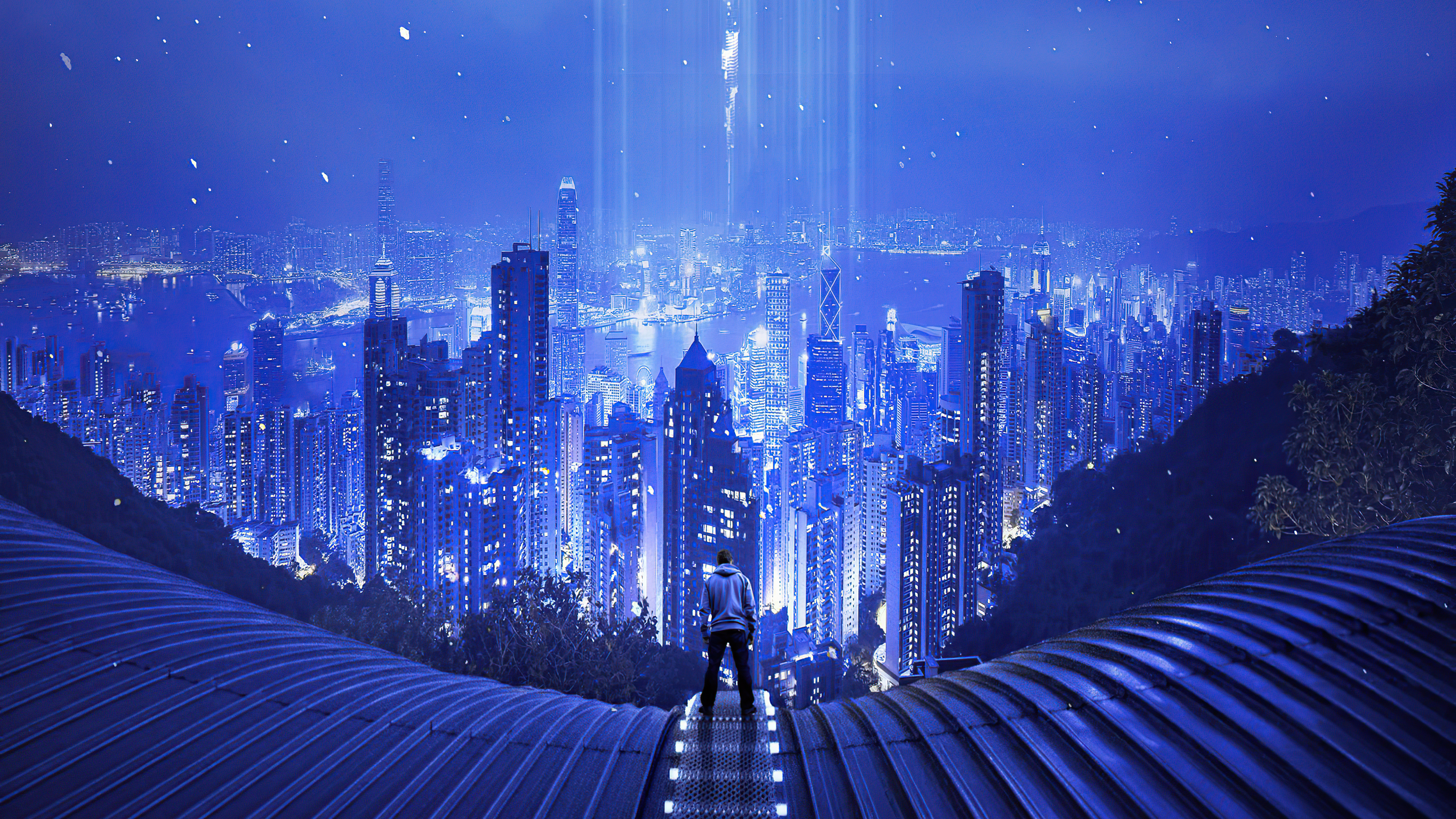Man in hoodie overlooking futuristic city at night HD Wallpaper
