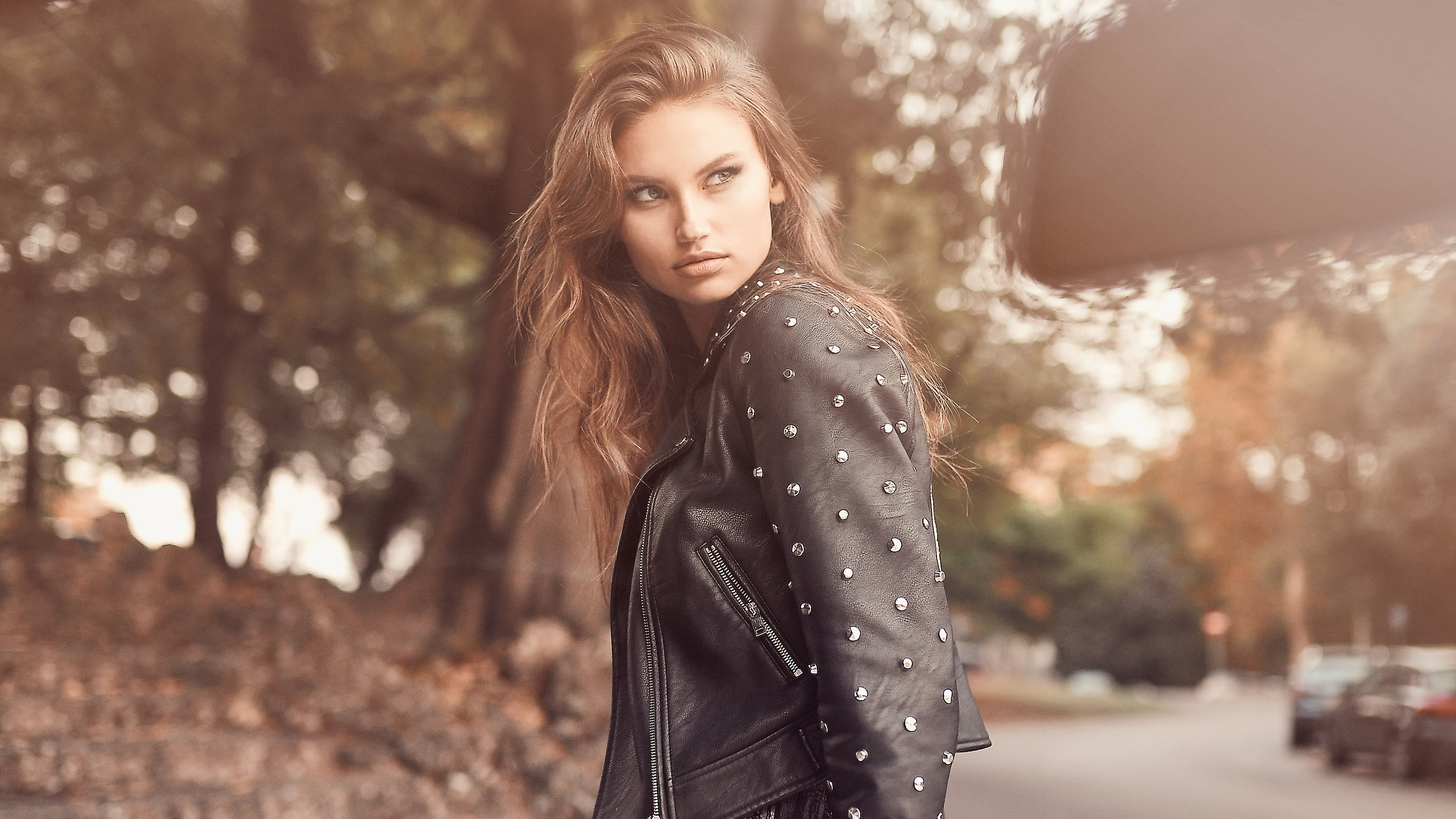 Model in studded leather jacket outdoors HD Wallpaper