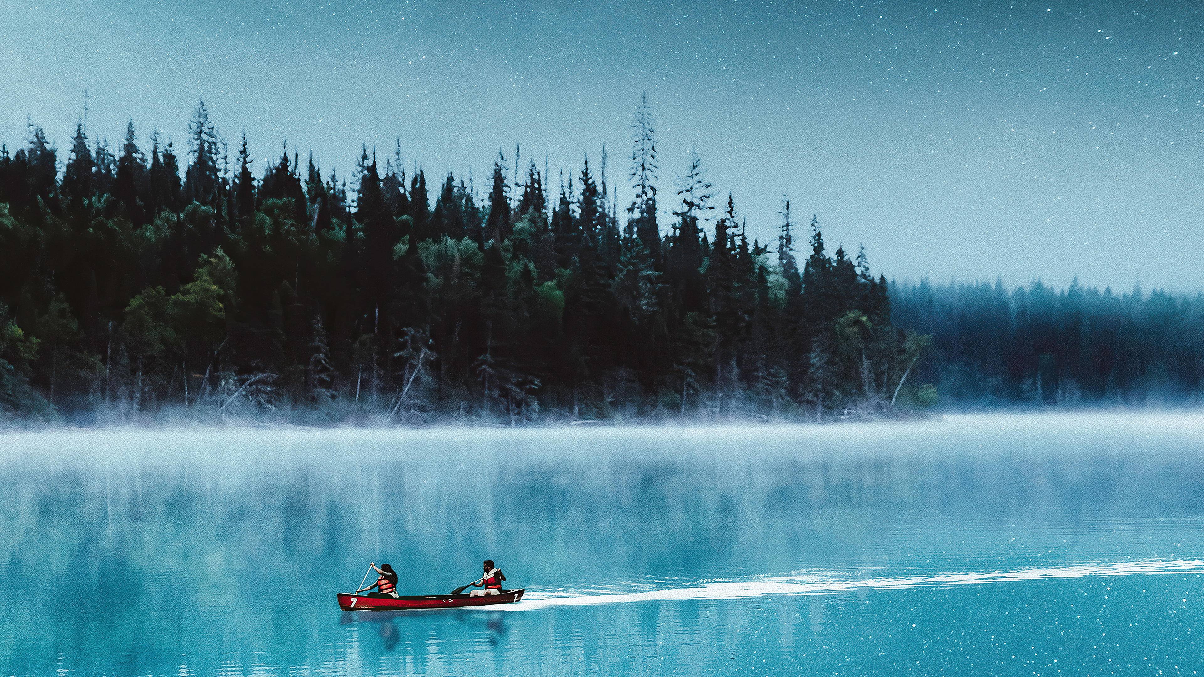 Two people in a canoe on a misty lake at night HD Wallpaper