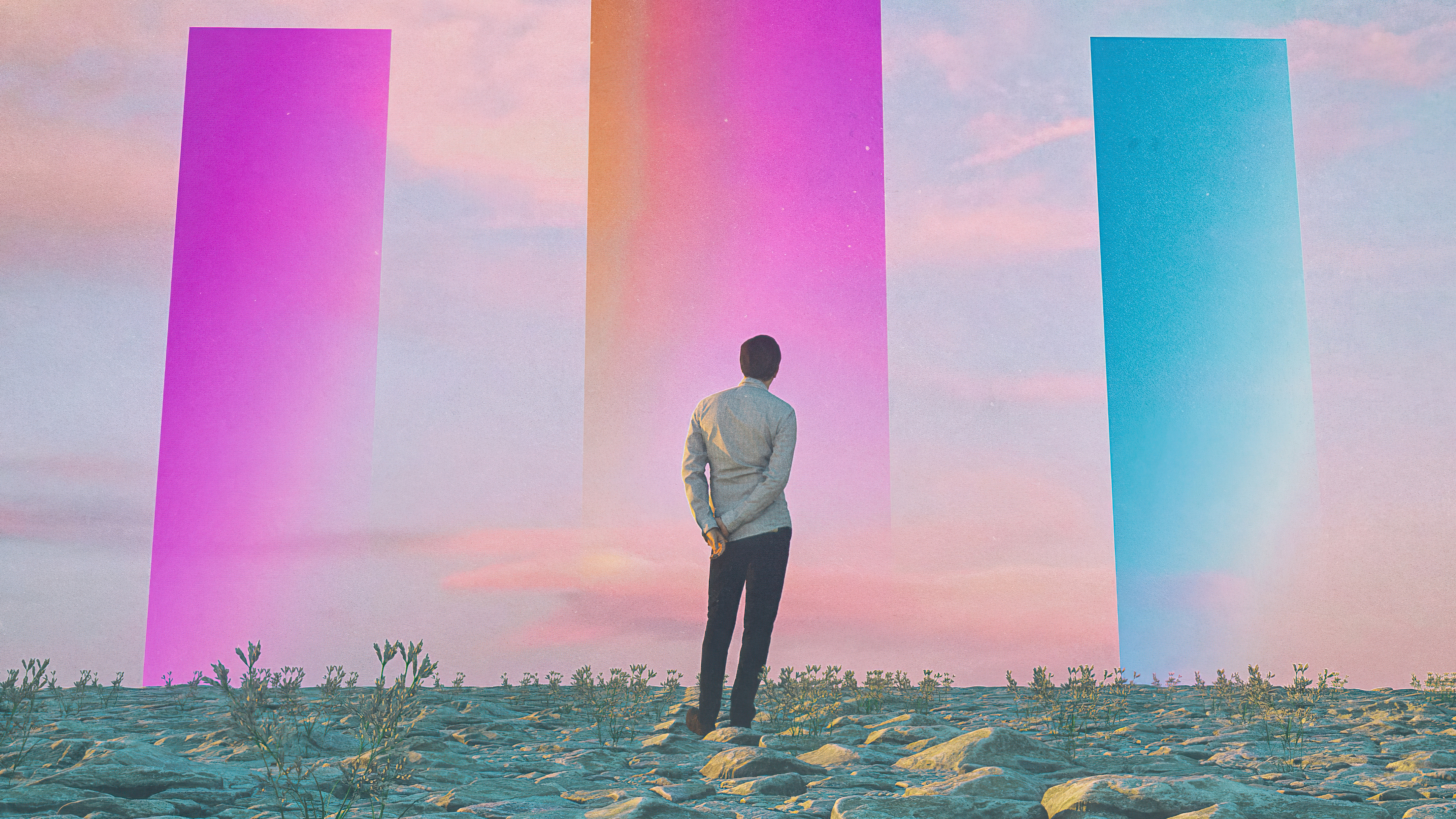 Man standing before three colorful portals in a desert landscape HD Wallpaper