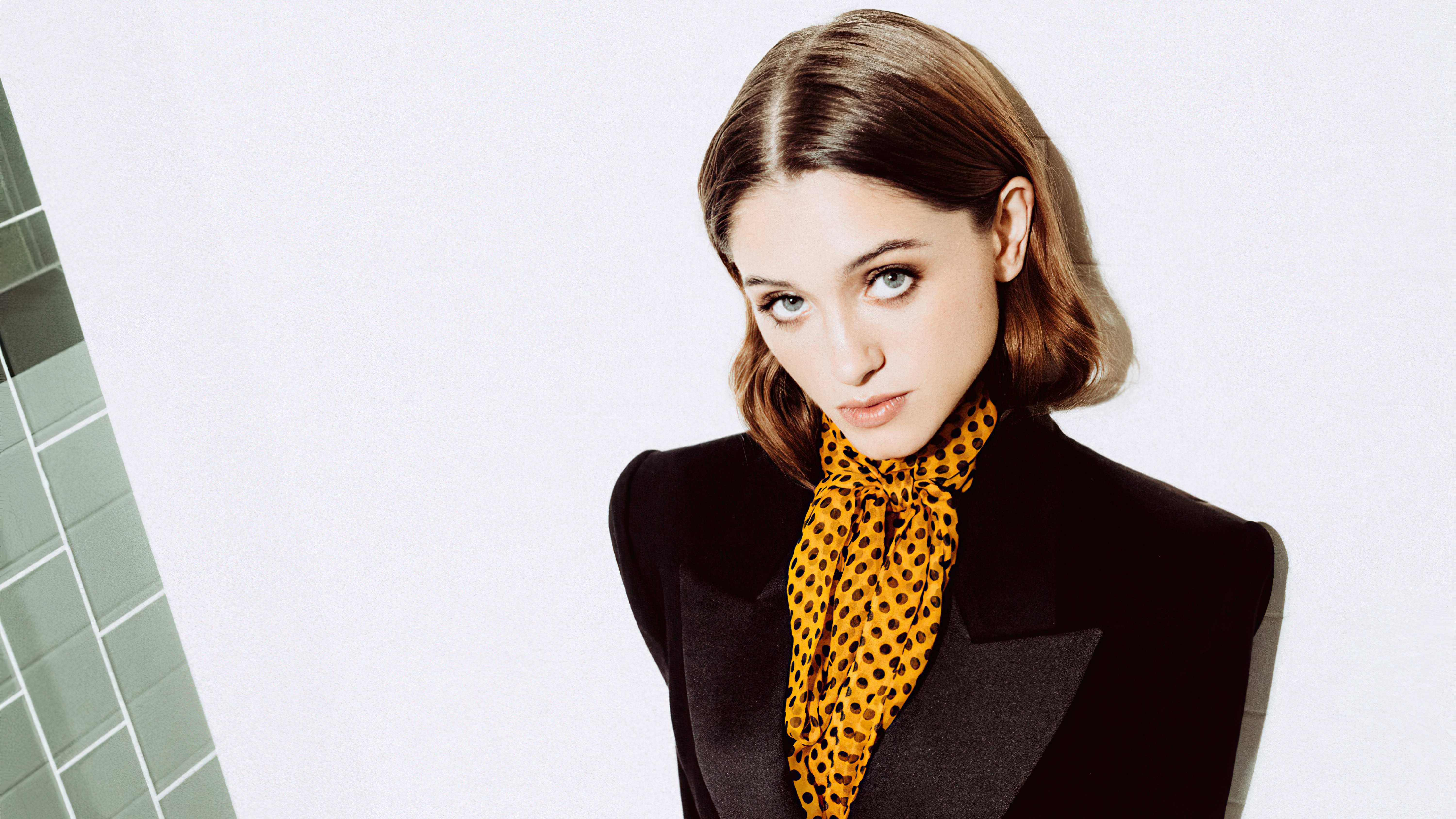 Natalia Dyer in a black blazer with a yellow polka dot scarf HD Wallpaper
