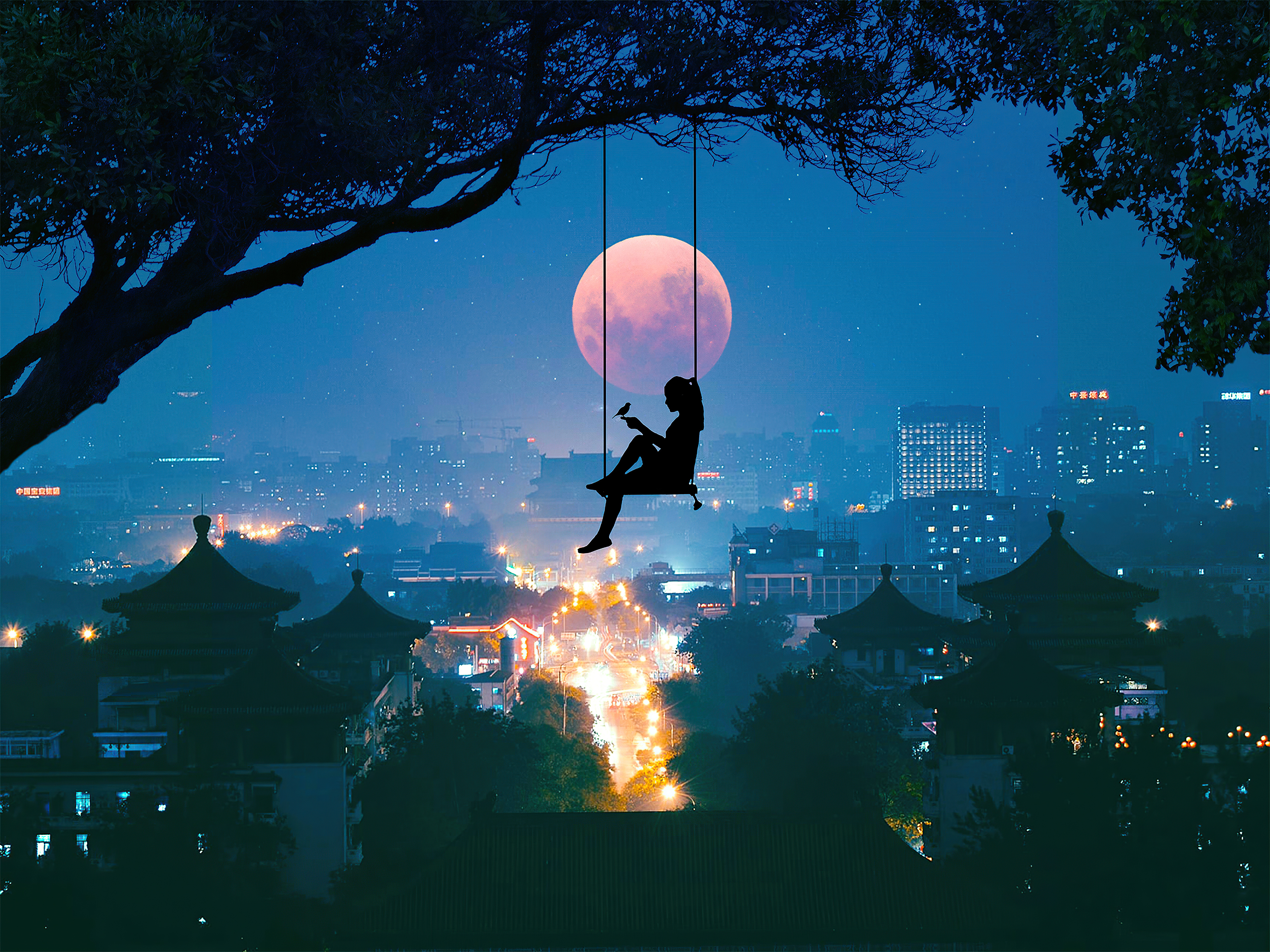 Silhouette of a person on a swing under a large tree with a full moon and city skyline HD Wallpaper