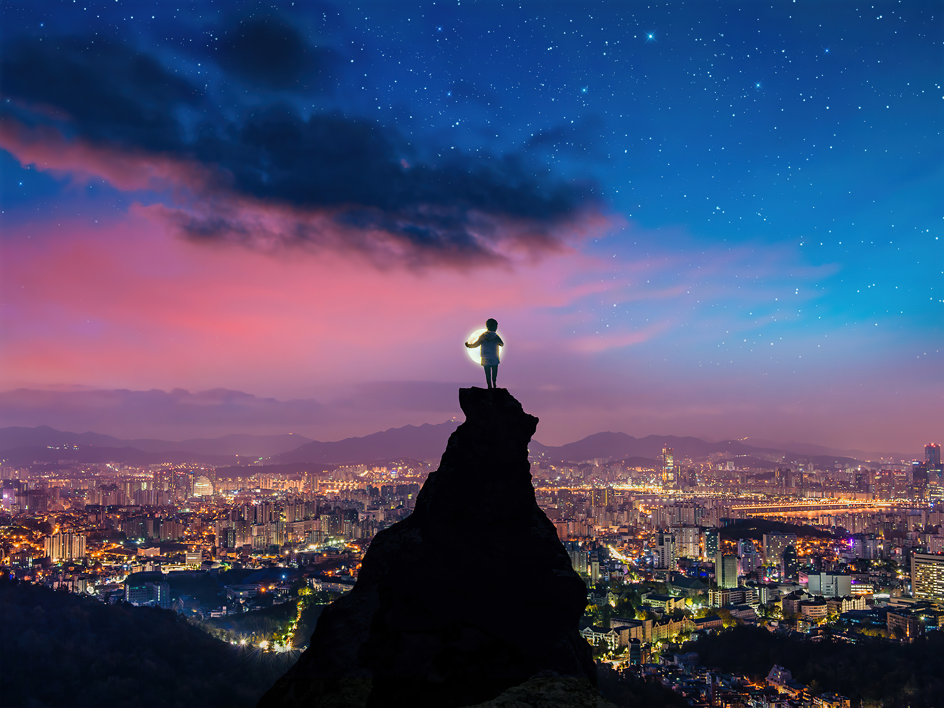 Child on cliff overlooking city at night HD Wallpaper