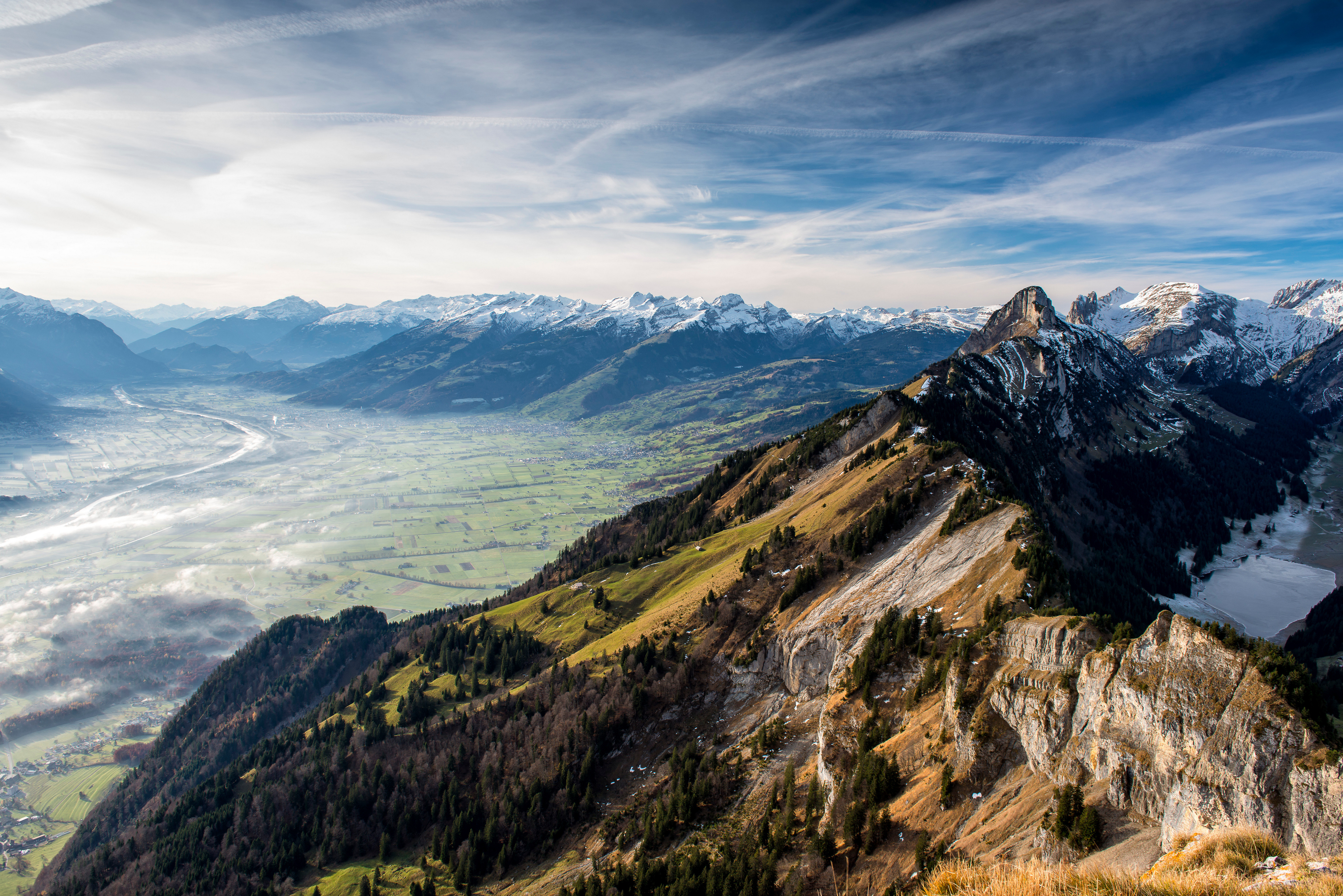 Mountain range with valley and snow-capped peaks HD Wallpaper