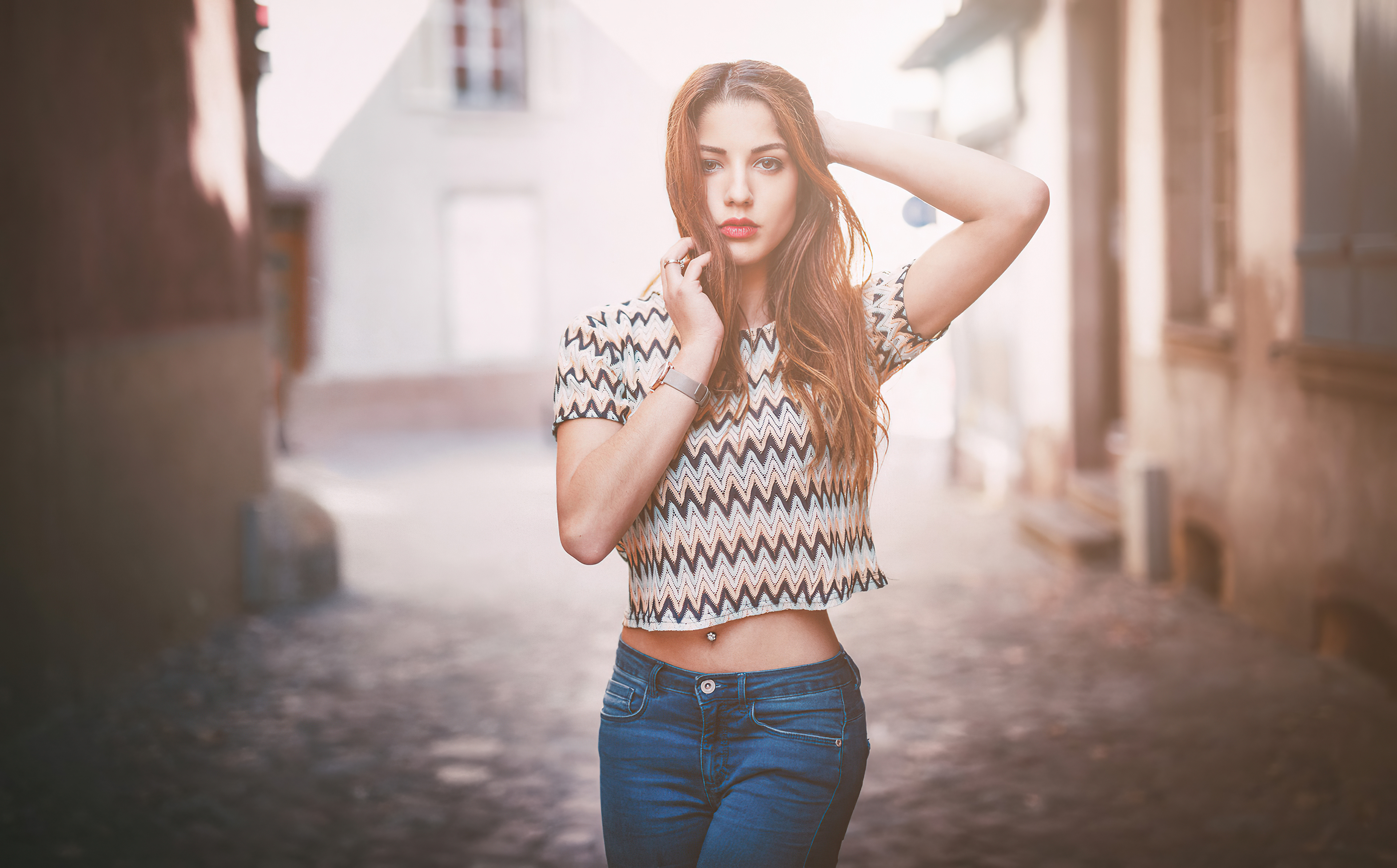 Young woman in patterned crop top and jeans HD Wallpaper