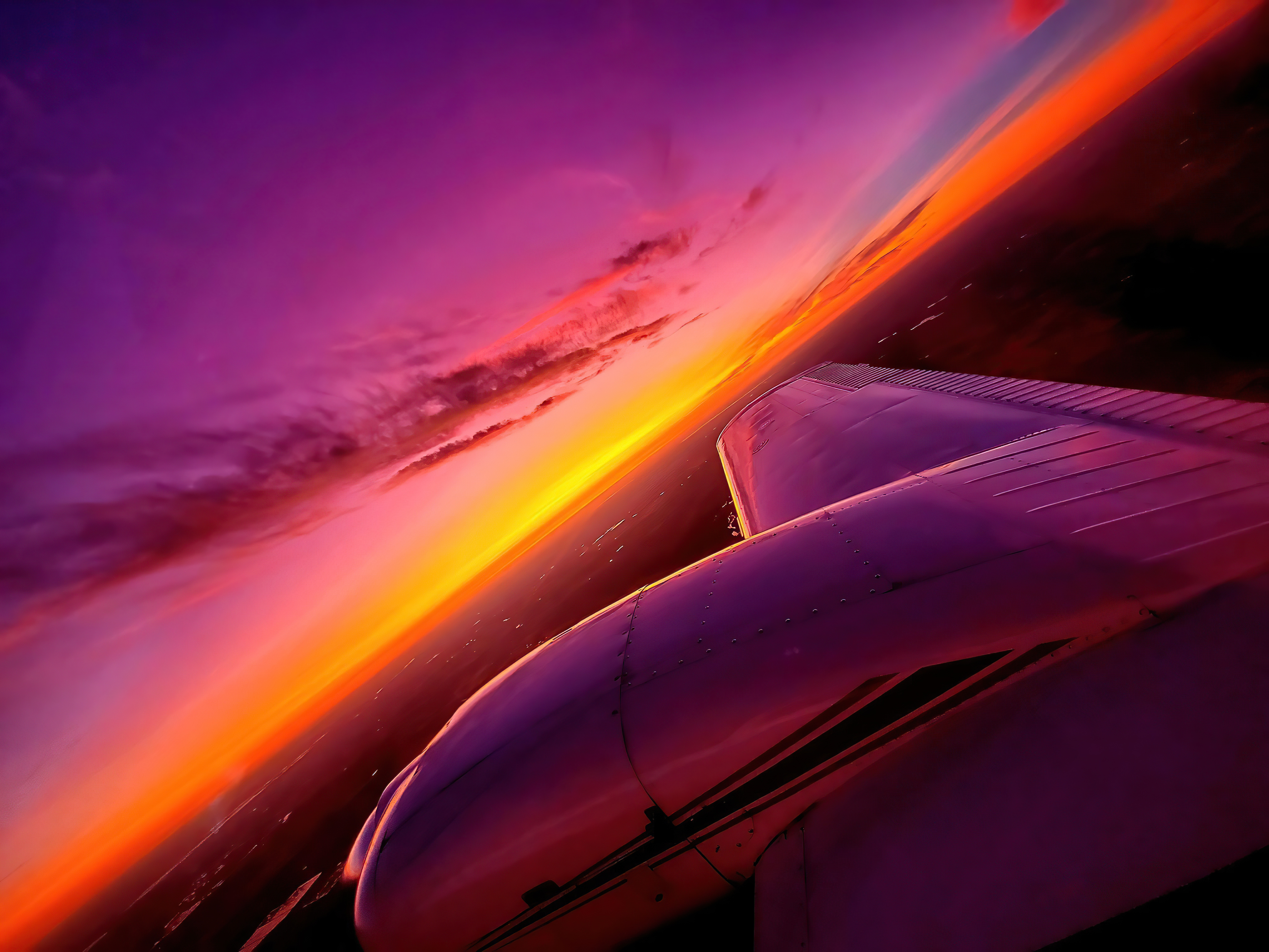 Airplane wing against a vibrant sunset sky HD Wallpaper