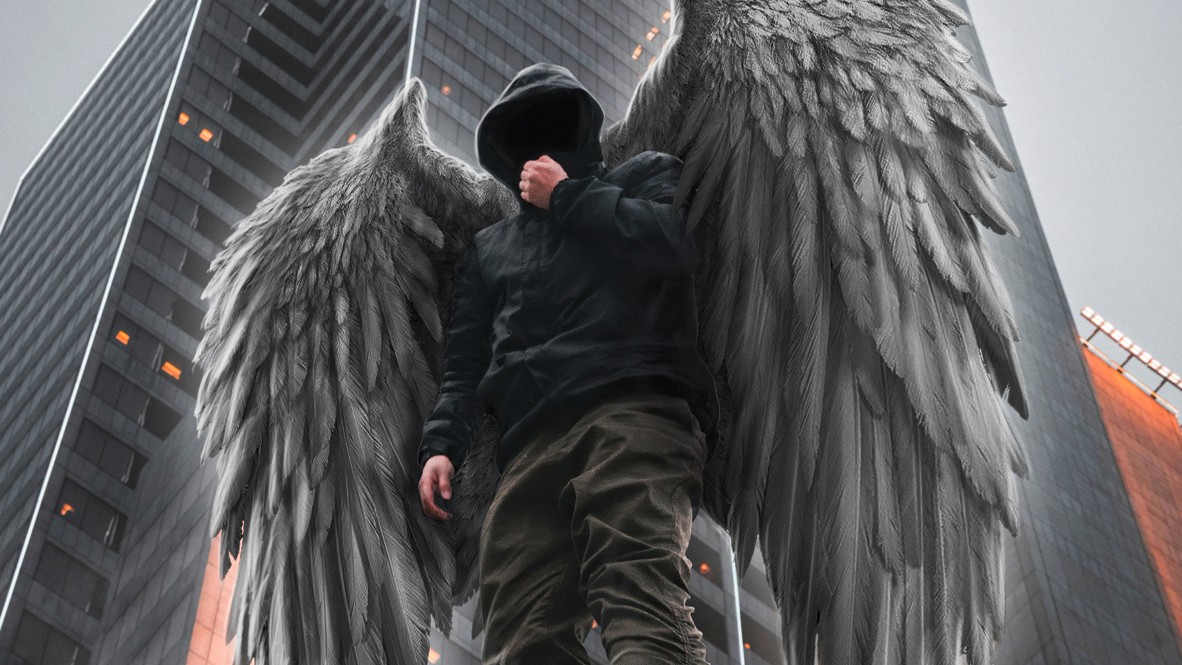 Hooded figure with angel wings in a city HD Wallpaper