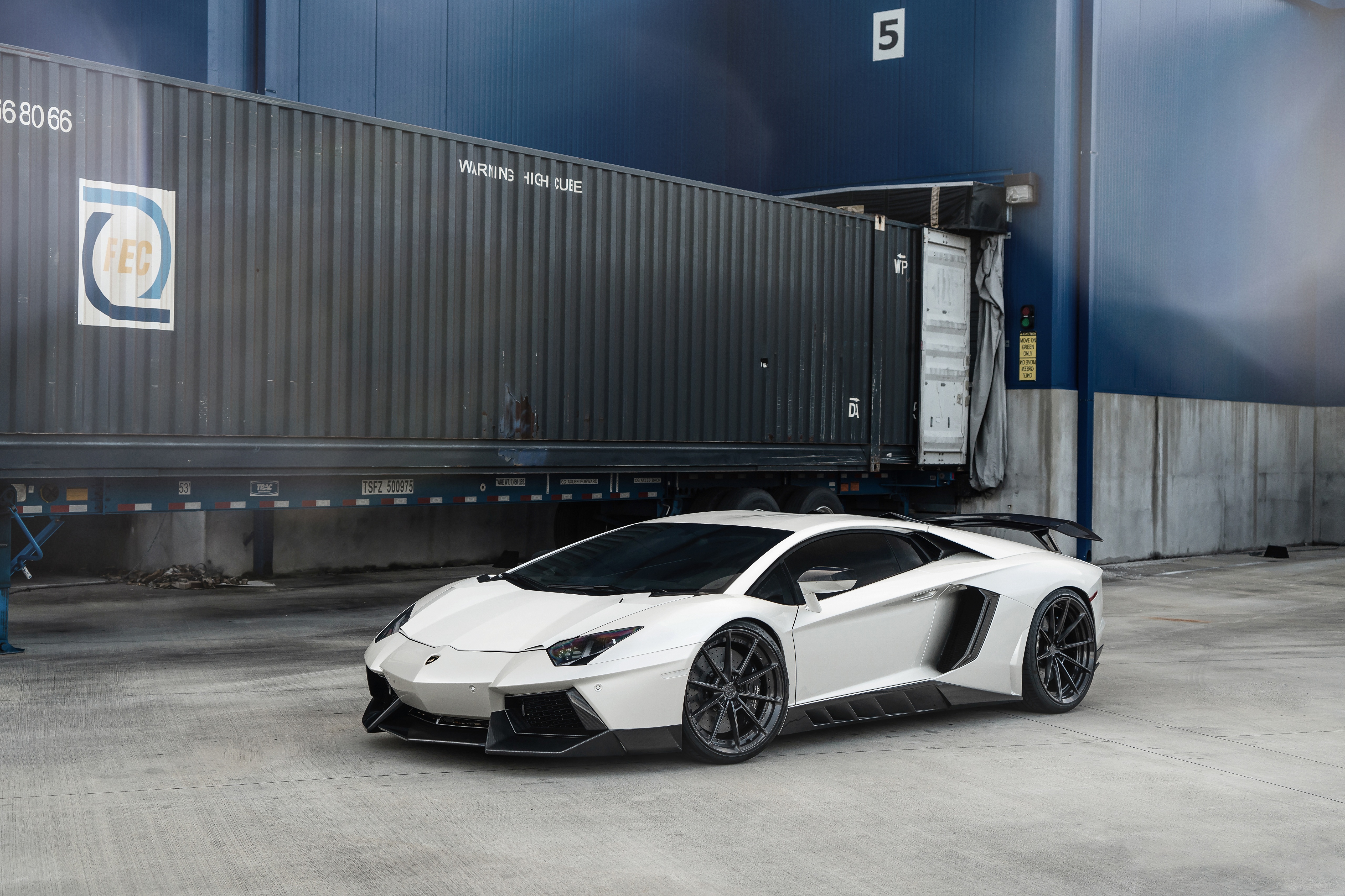 White Lamborghini Aventador parked near shipping containers HD Wallpaper