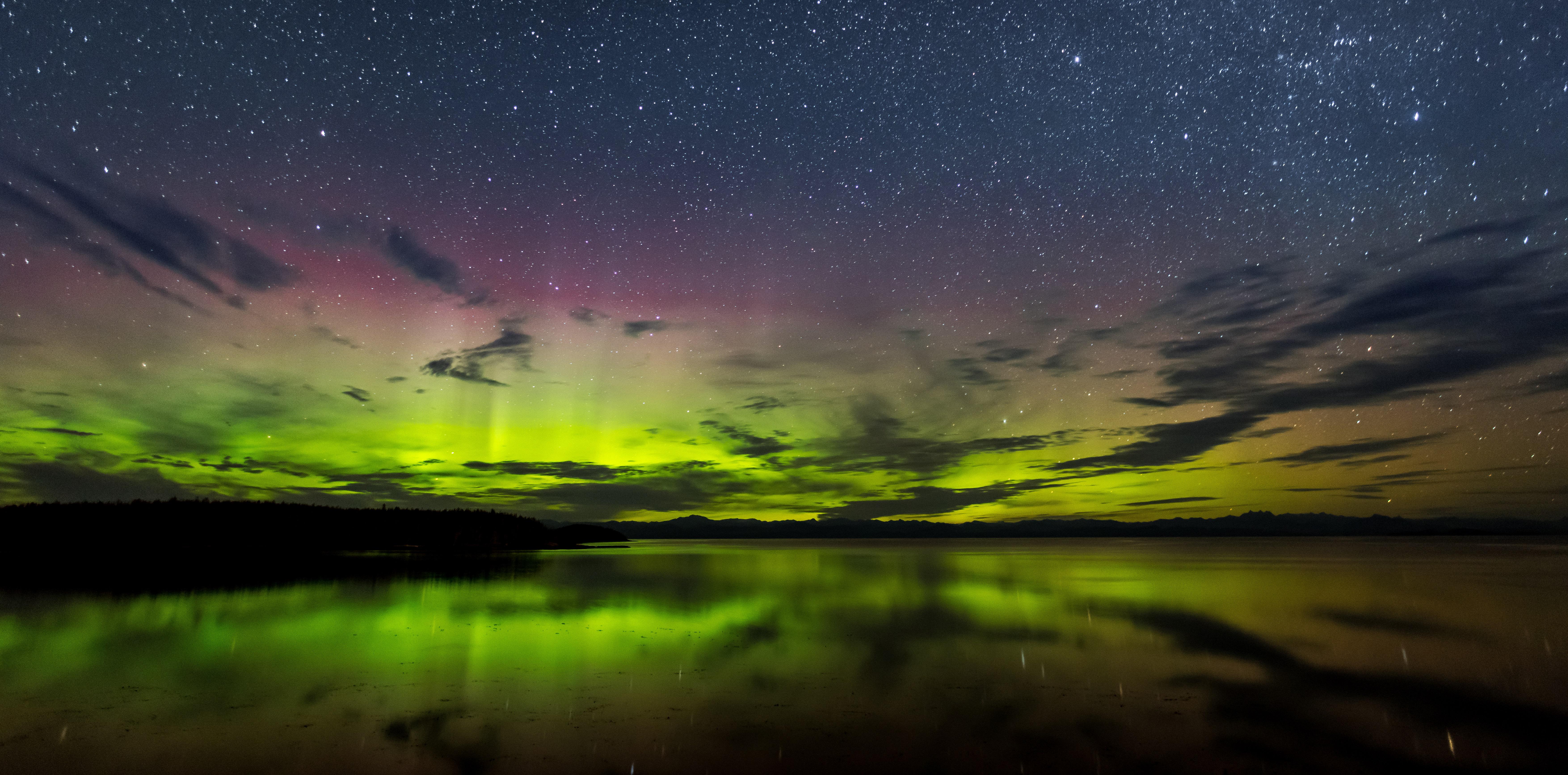 Aurora Borealis over a lake at night HD Wallpaper