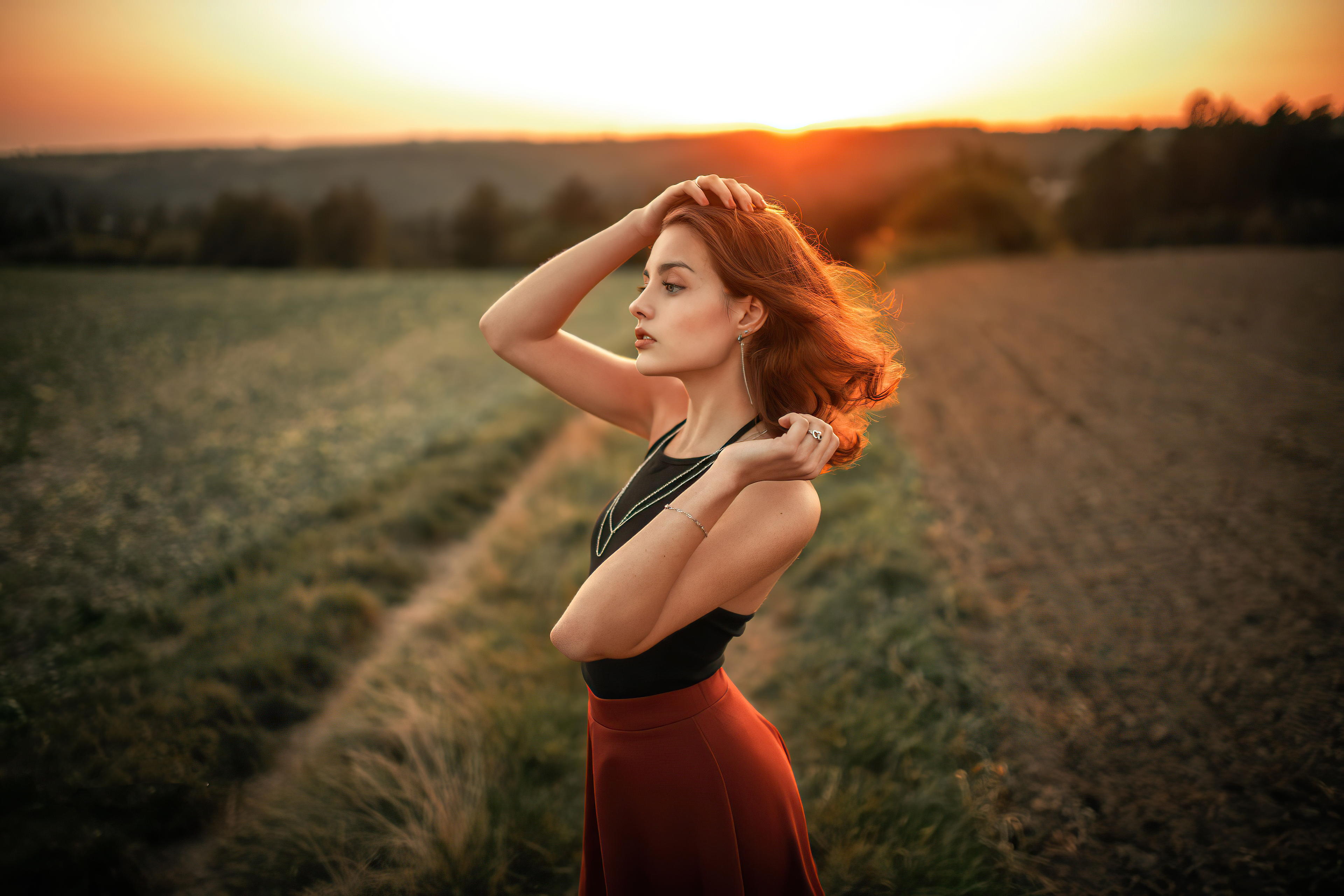 Woman with red hair in a field at sunset HD Wallpaper