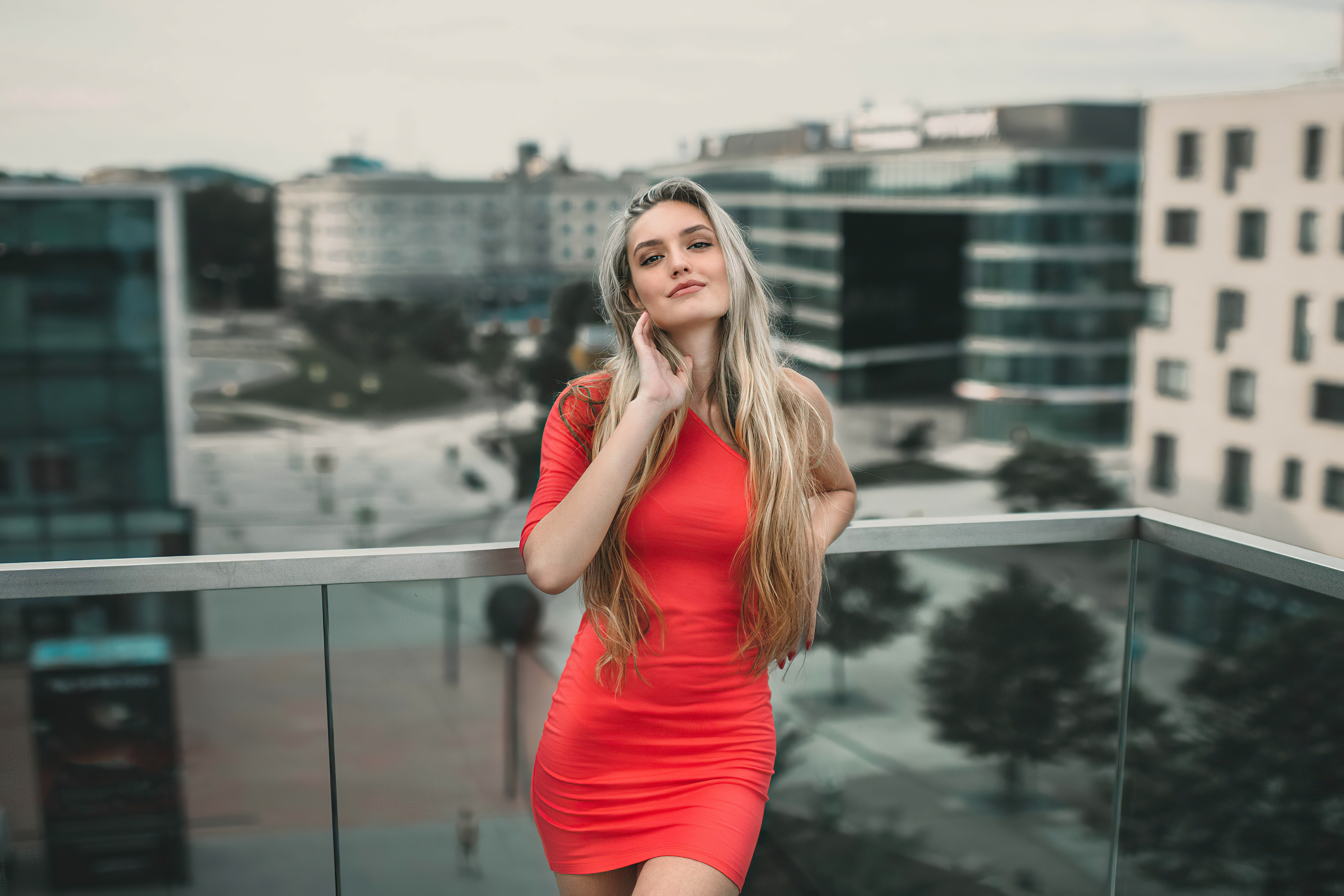 Blonde model in red dress on balcony 4K HD Wallpaper