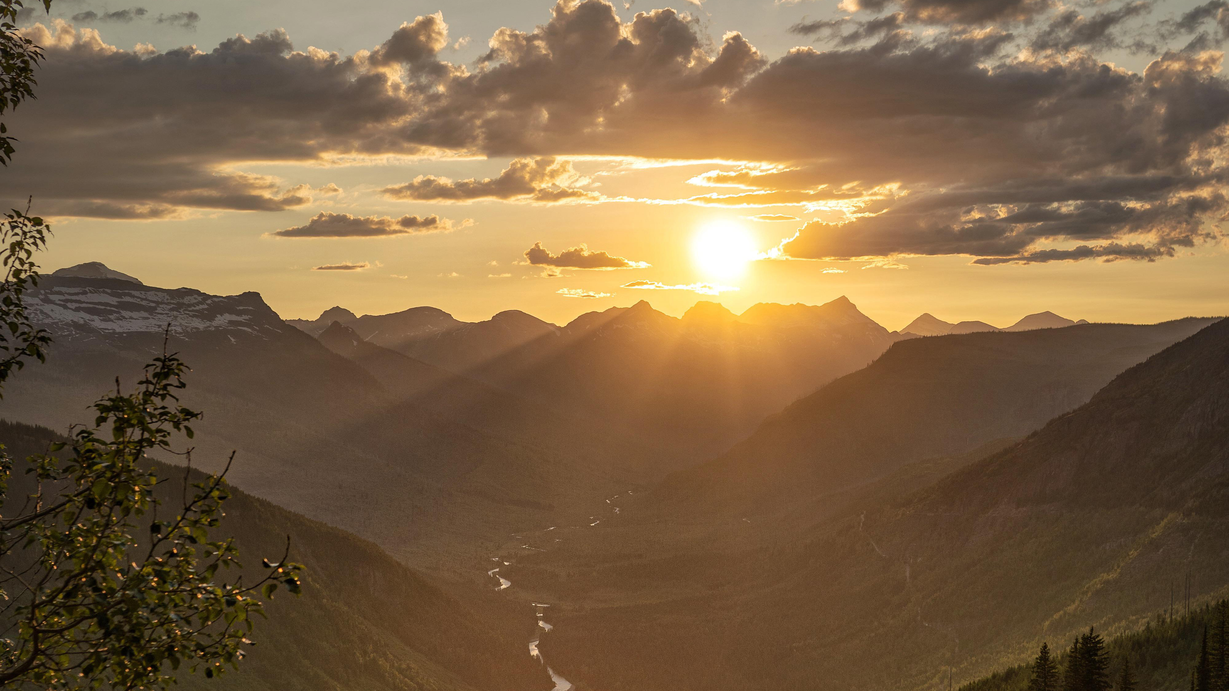 Sunset over mountains with clouds and valley HD Wallpaper