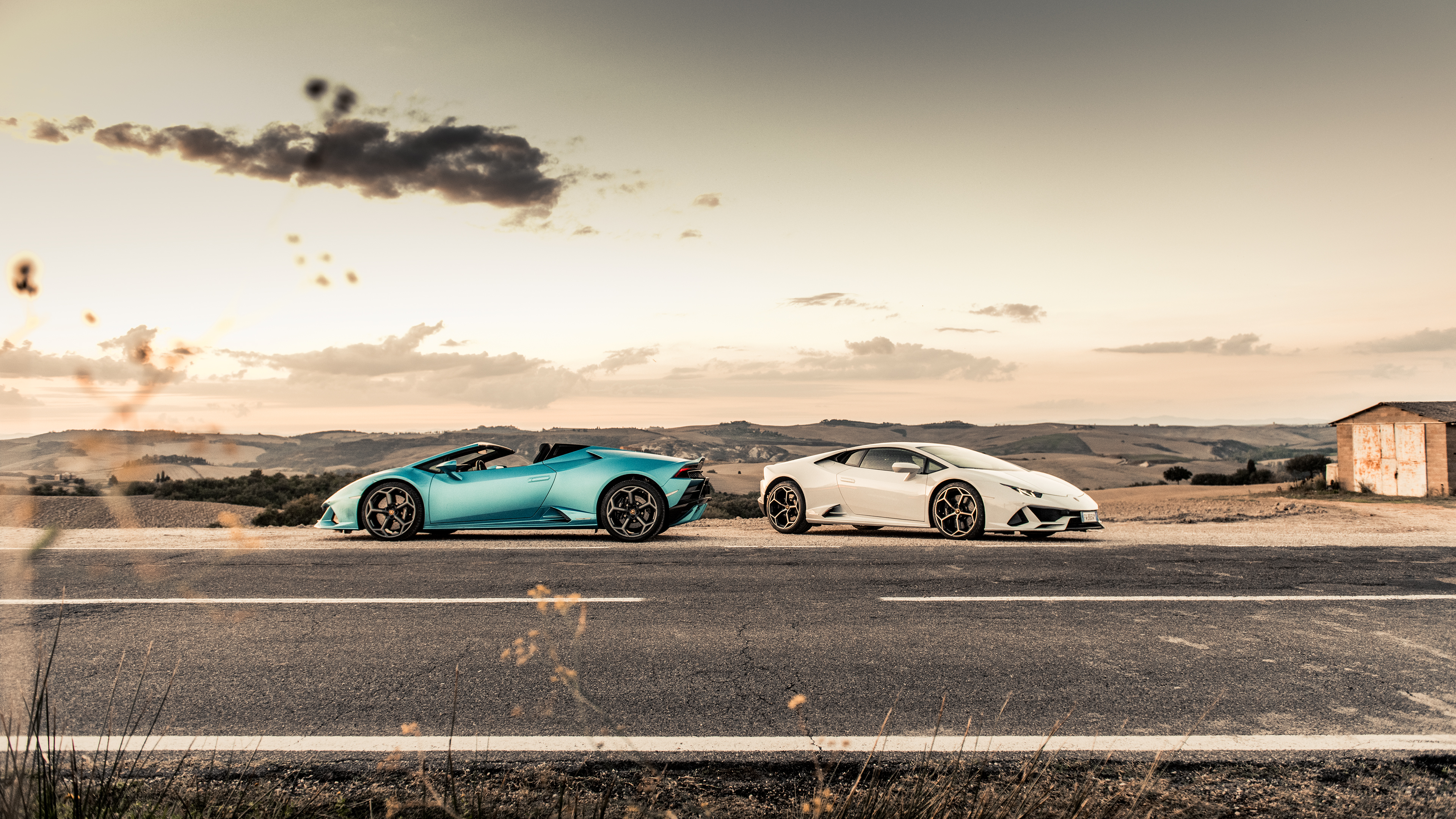 Two Lamborghinis on a road in Tuscany HD Wallpaper