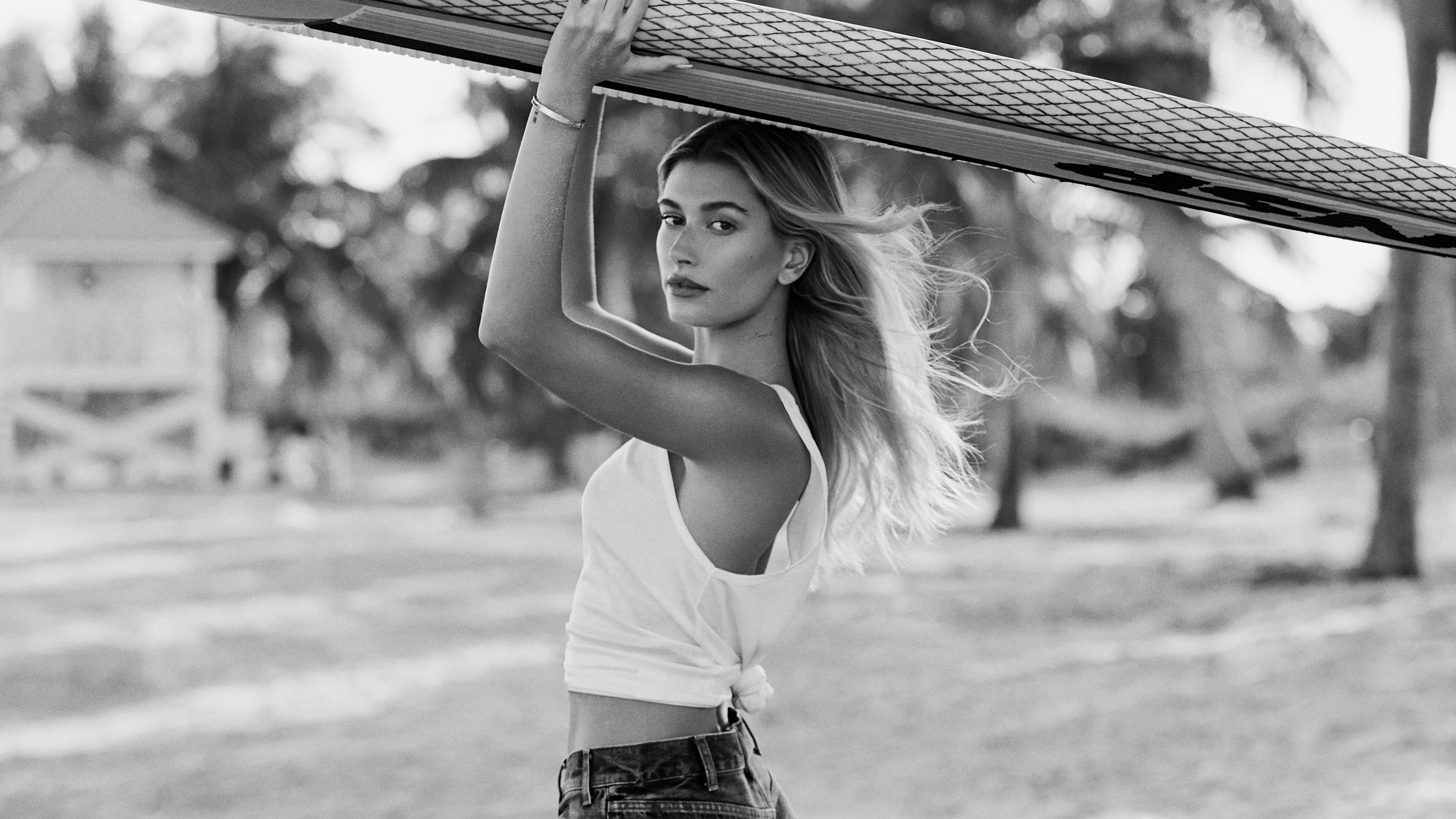 Hailey Bieber holding a surfboard, monochrome HD Wallpaper