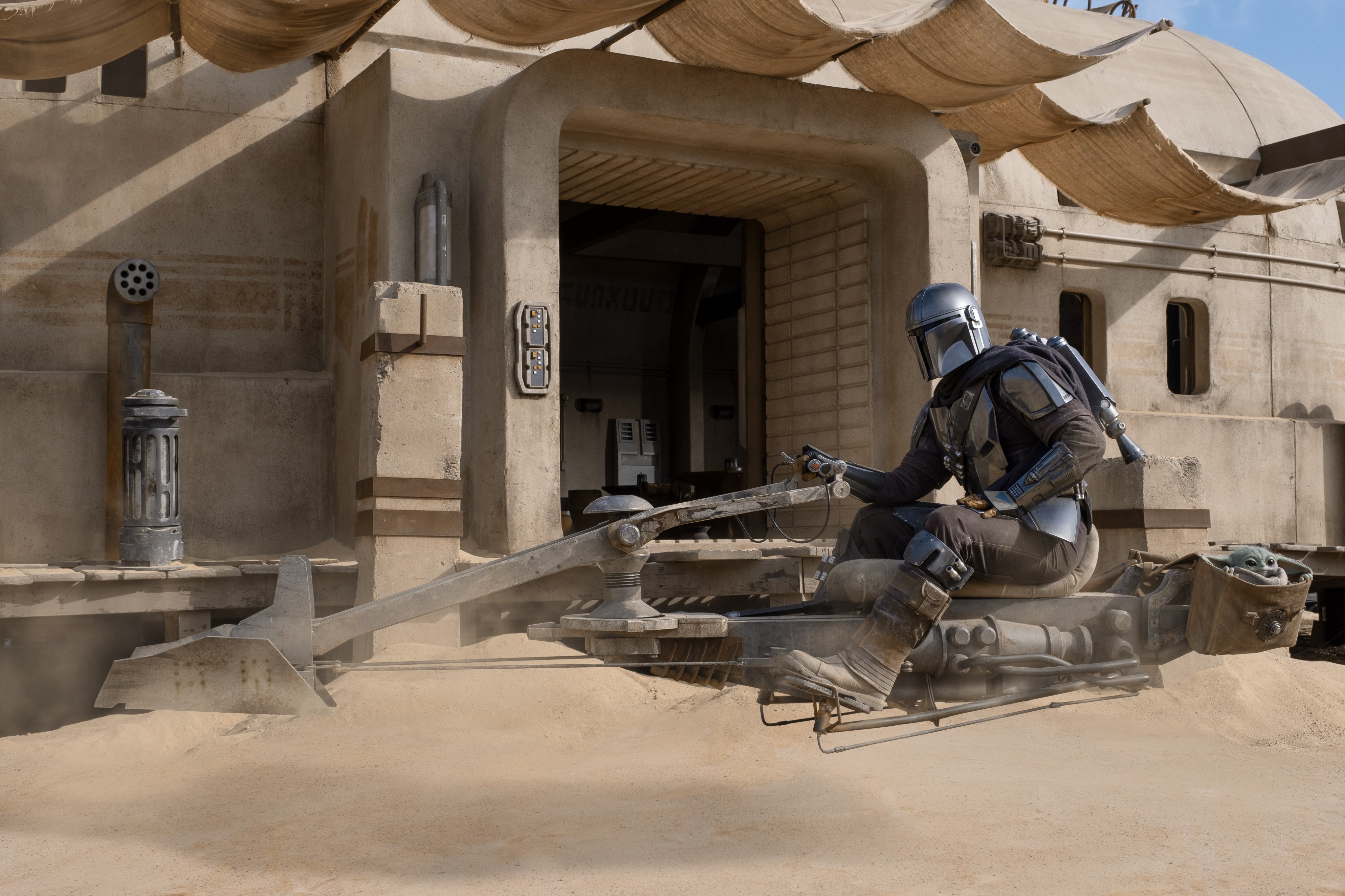 The Mandalorian from Star Wars on a speeder bike HD Wallpaper
