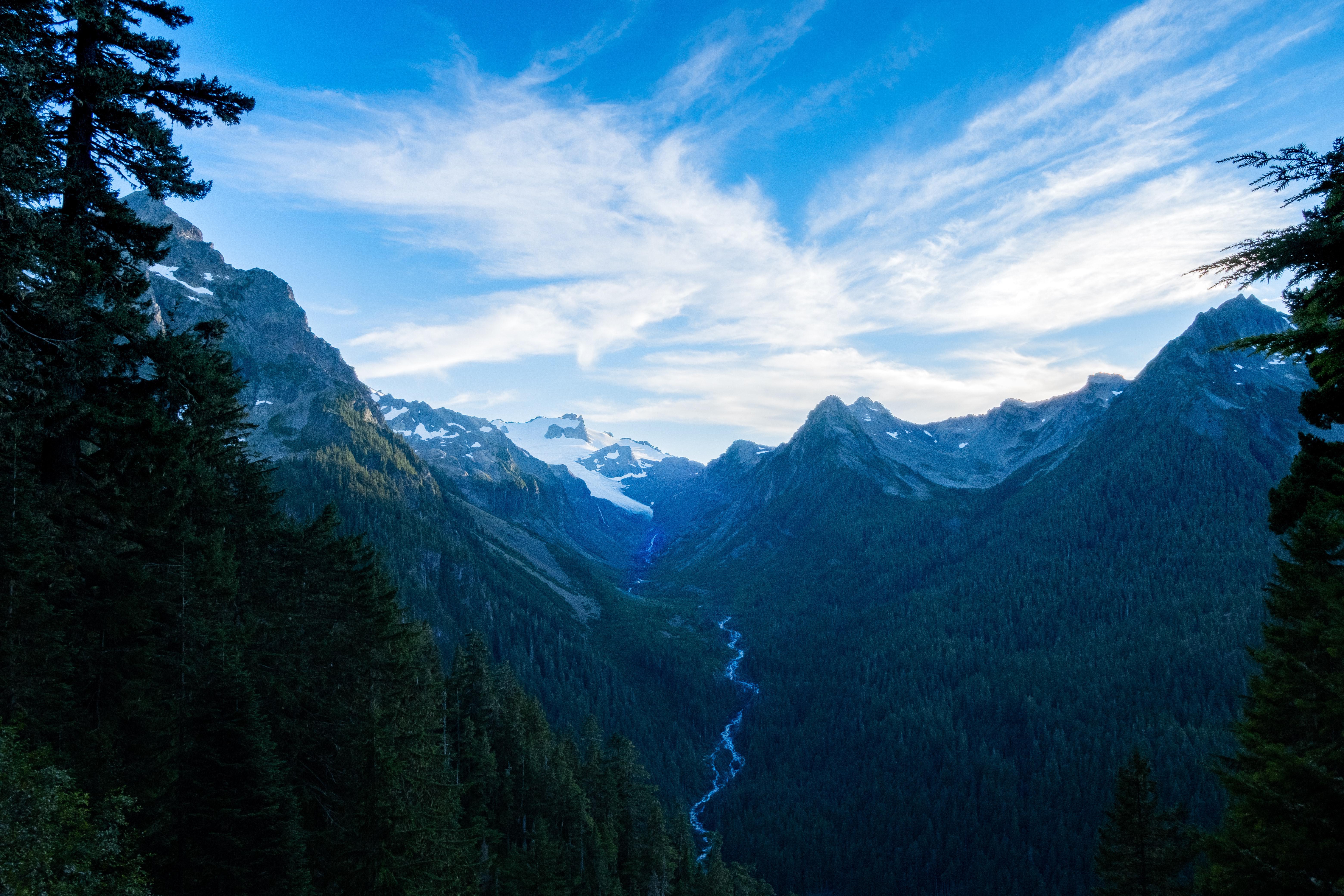 Mountain valley with river and snow-capped peaks HD Wallpaper