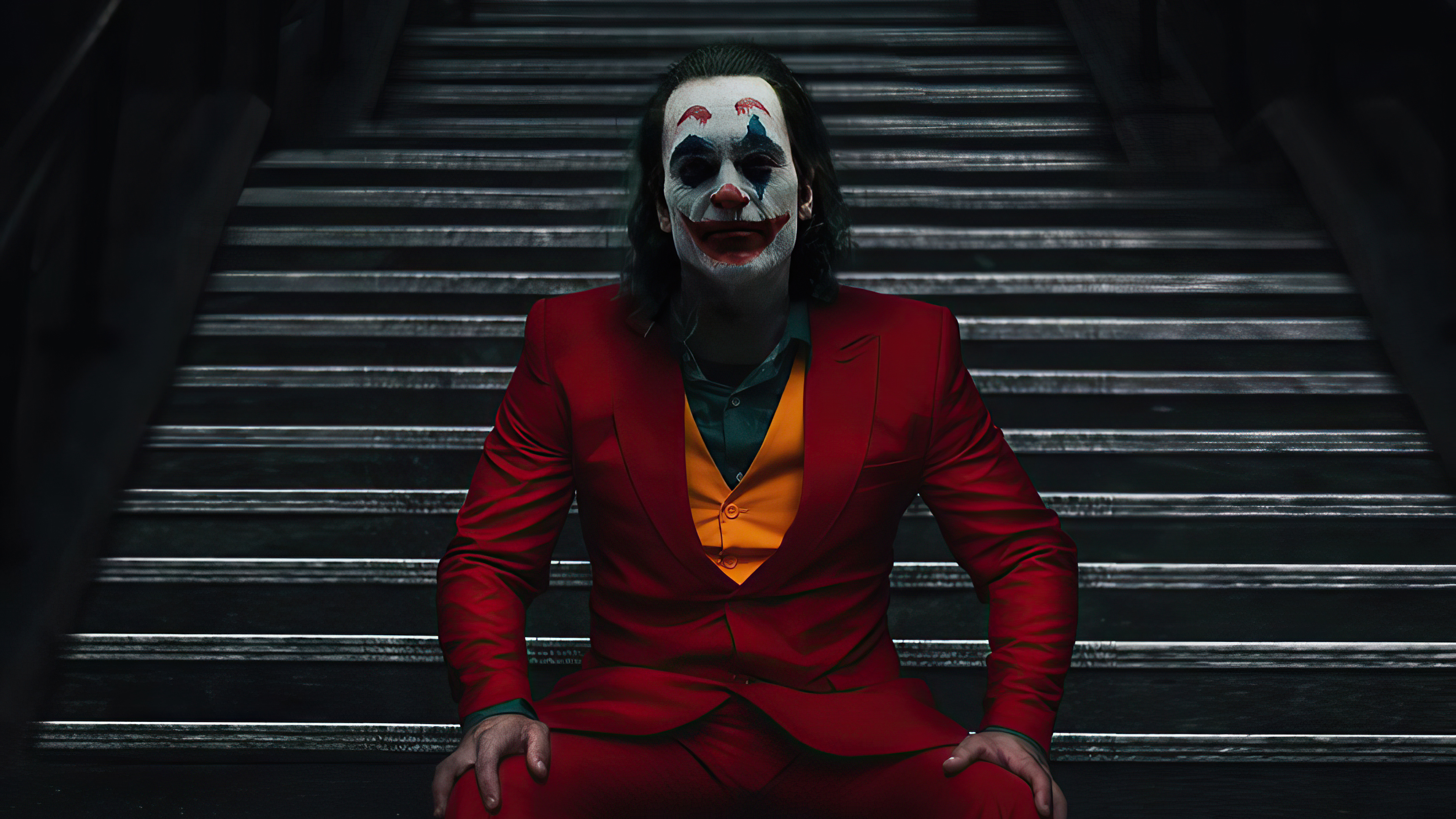Joker sitting on stairs 4K HD Wallpaper