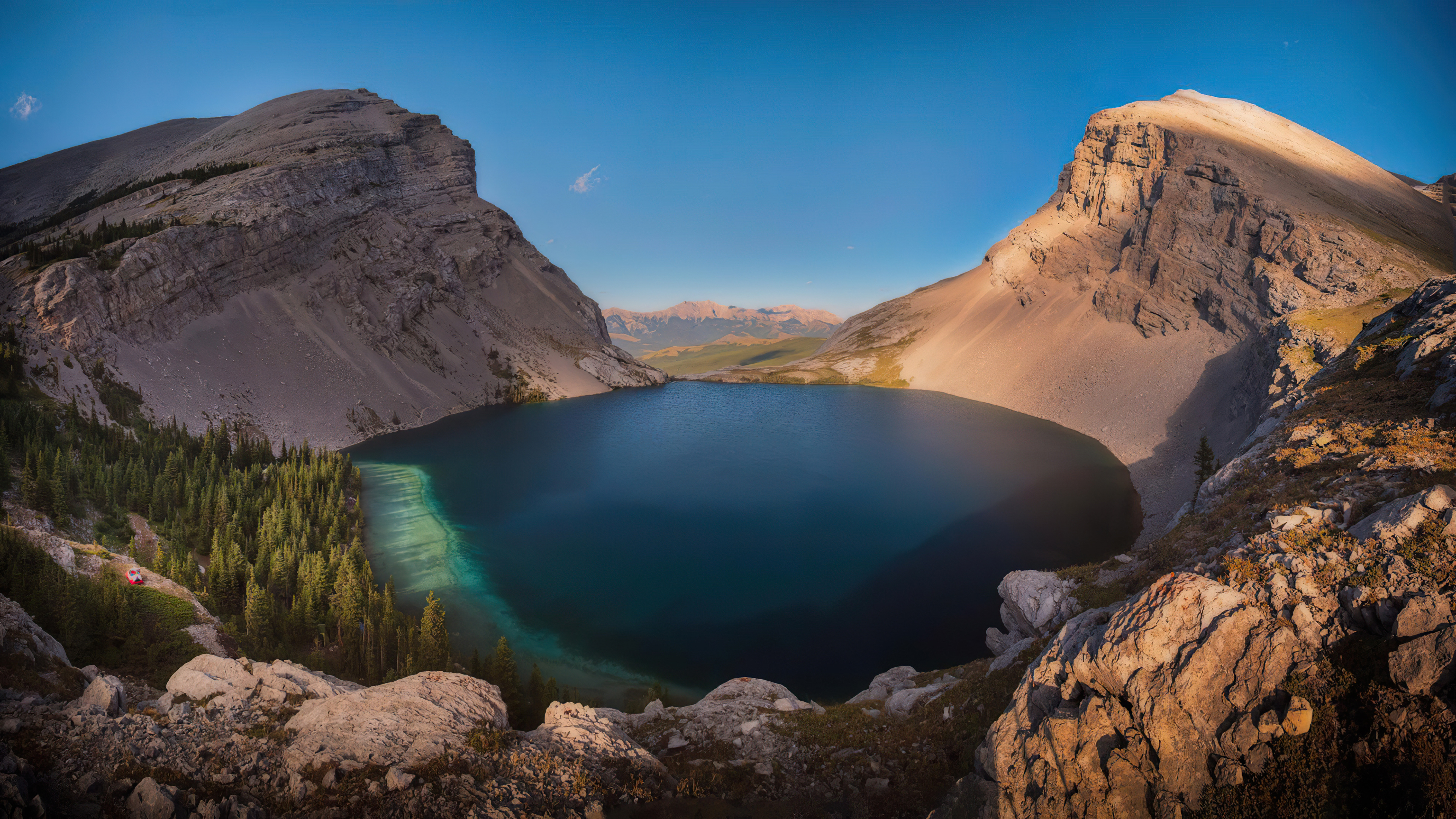 Mountain lake surrounded by rocky peaks and pine trees HD Wallpaper