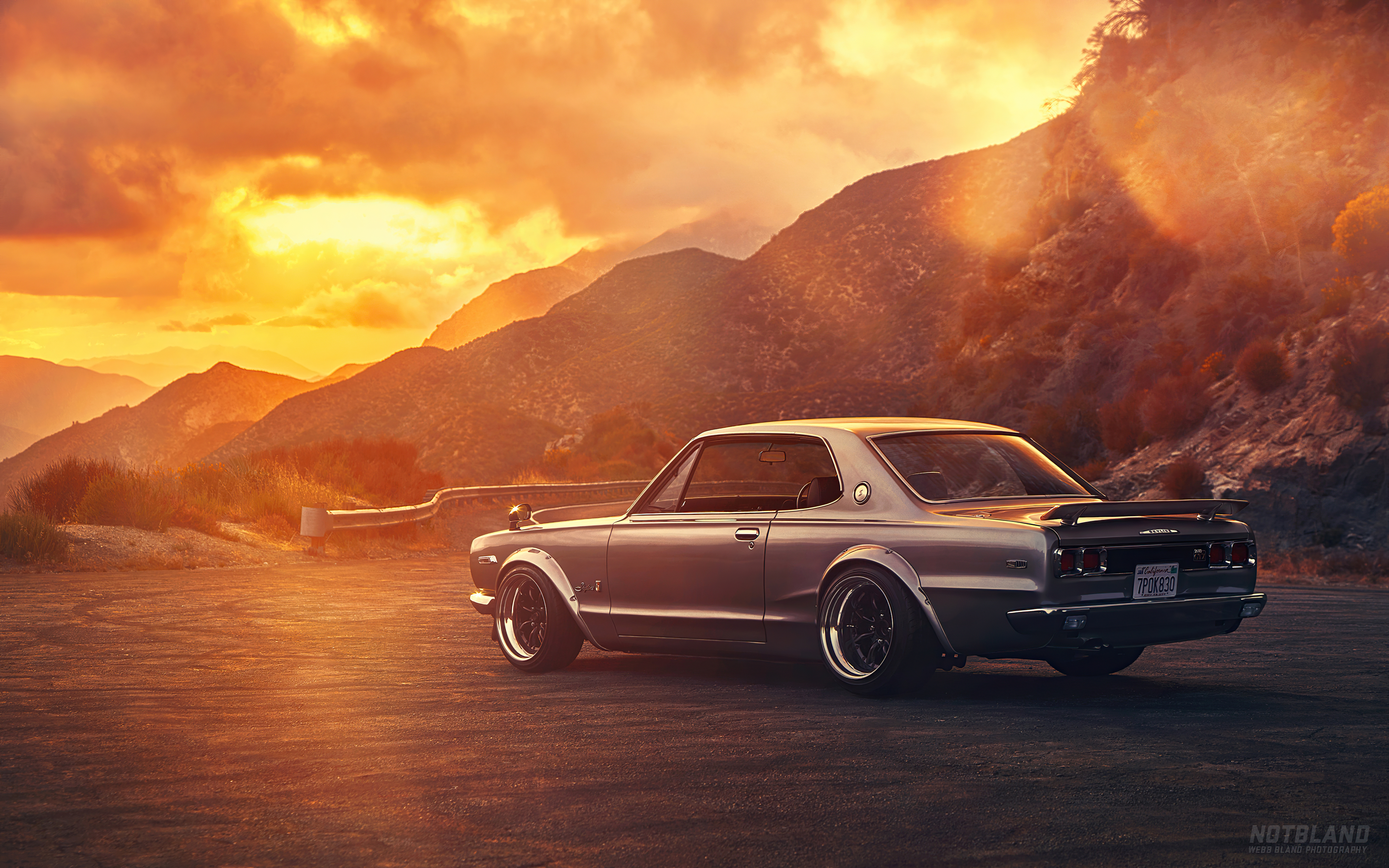 Classic Japanese car on a mountain road at sunset HD Wallpaper